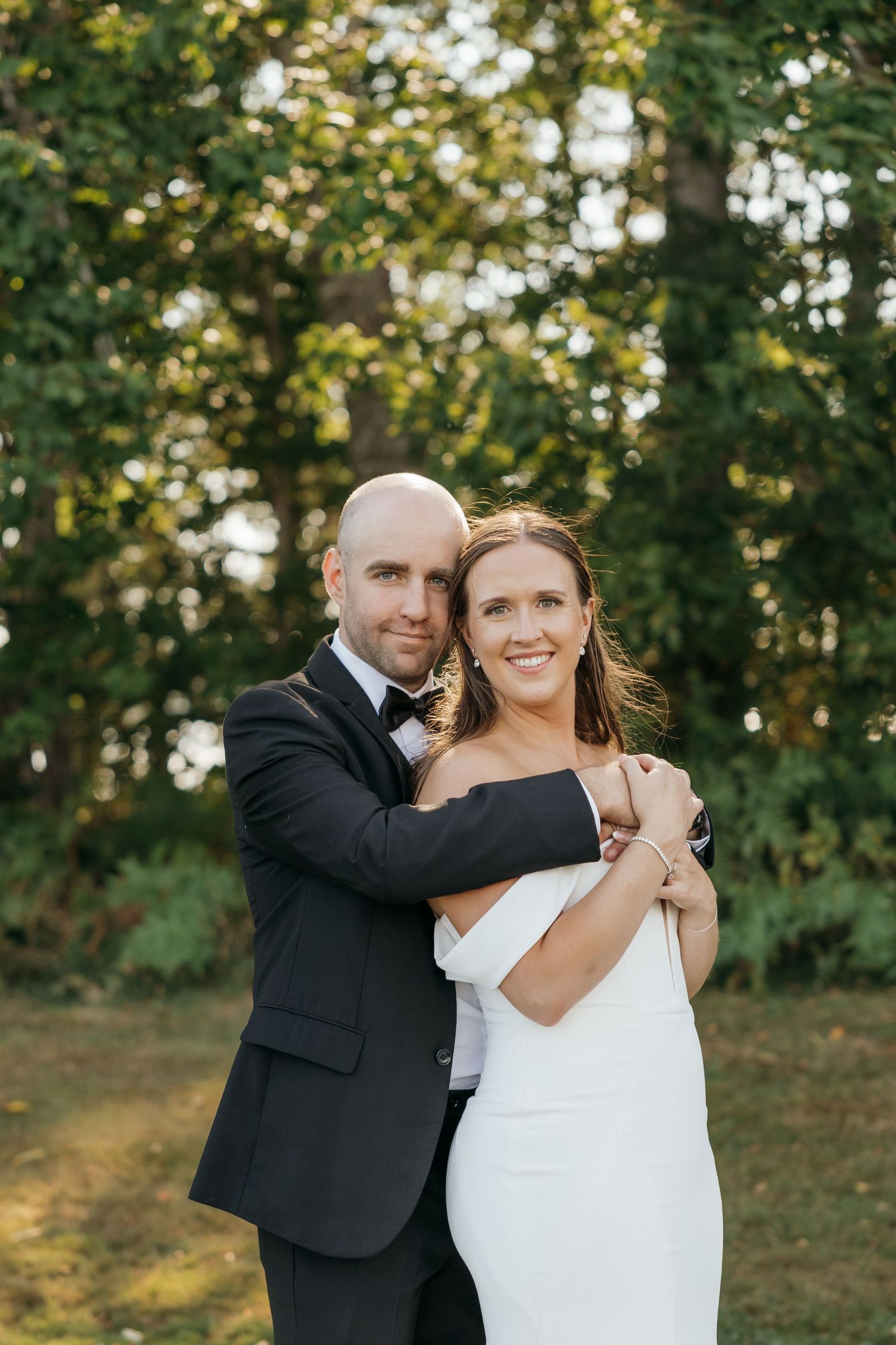 Romantic outdoor portrait session in a sunlit wooded area.