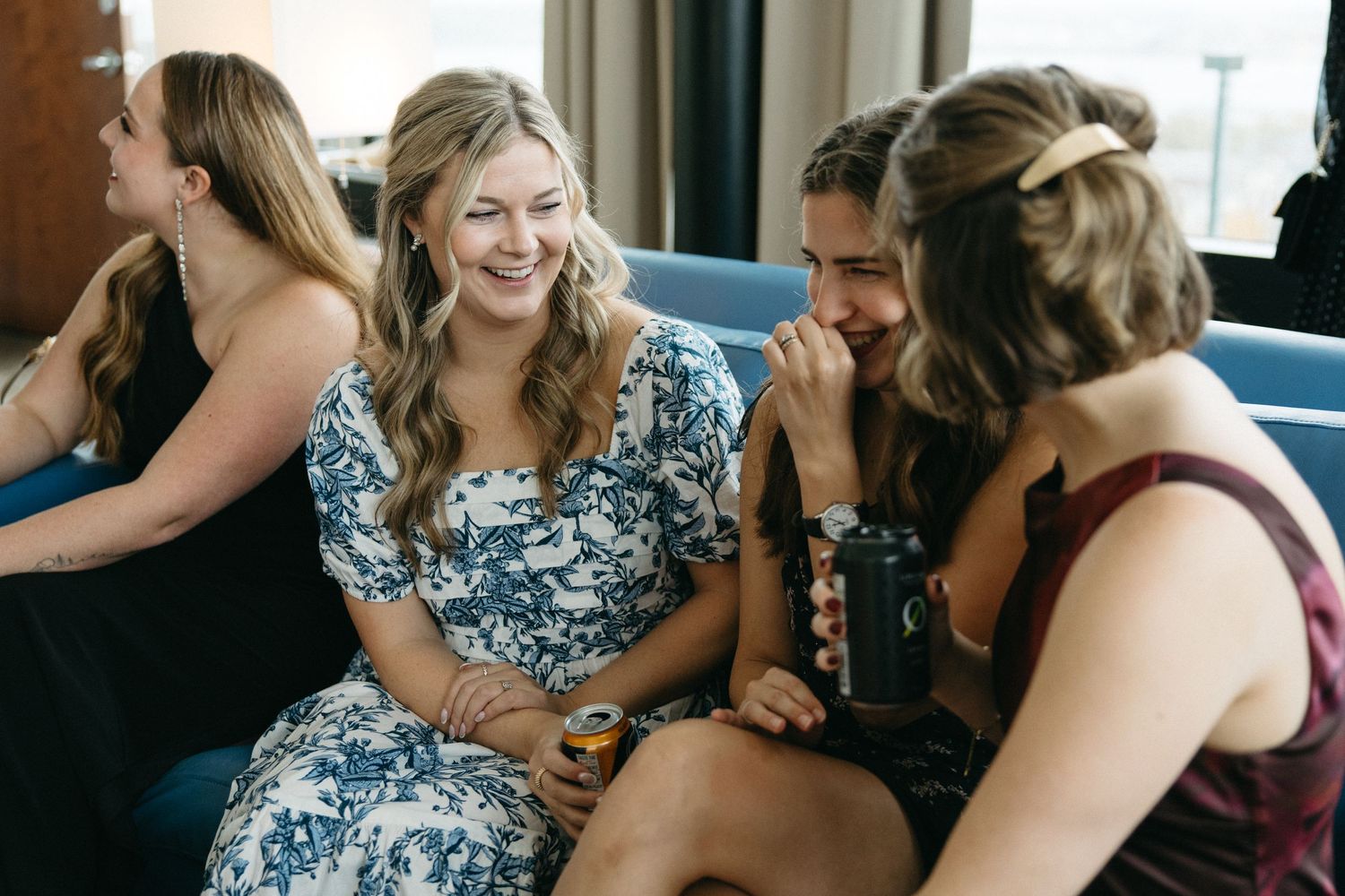 Wedding party members sharing laughs during candid moments.