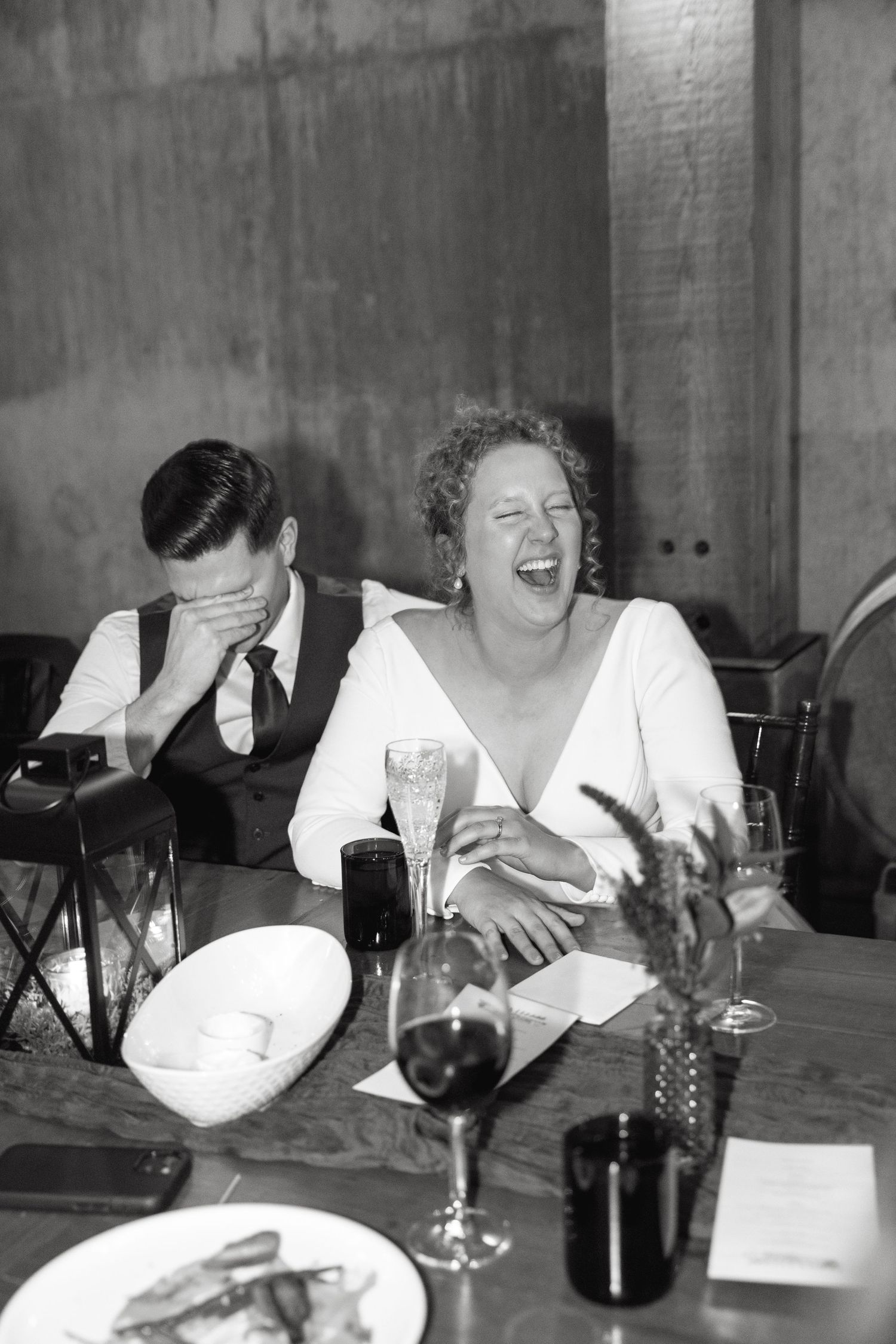 Lively dinner conversation around a table with wine glasses and ambient lighting.