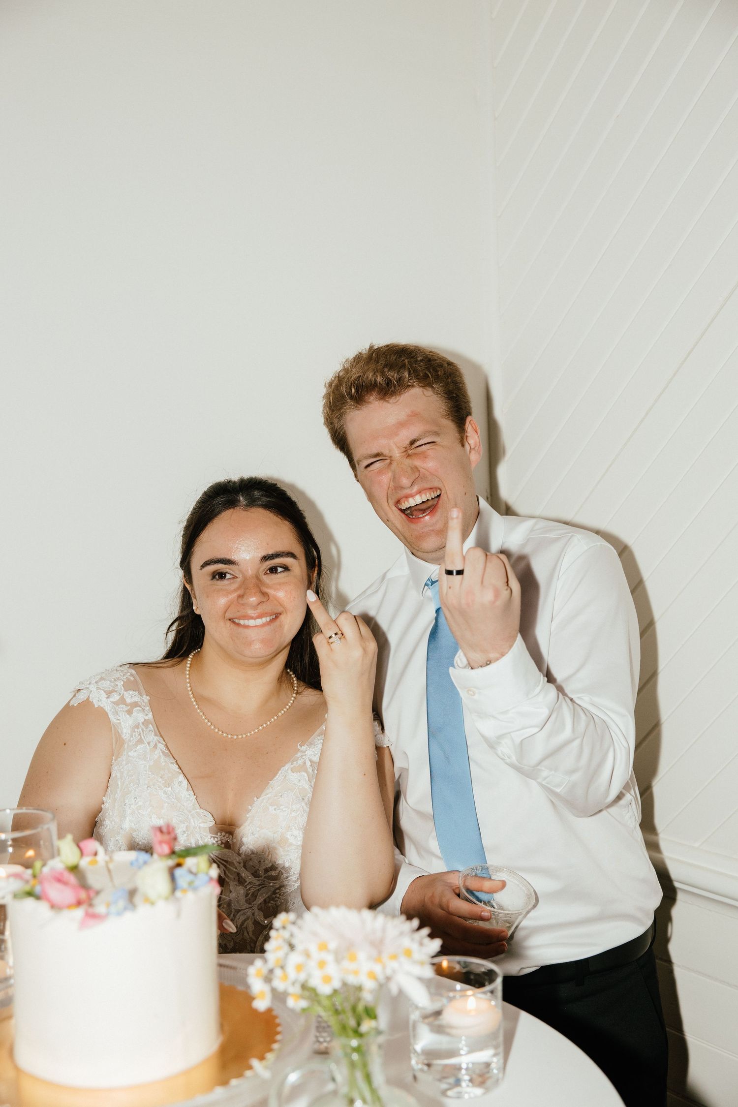 Joyful moment shared by couple with their wedding cake.