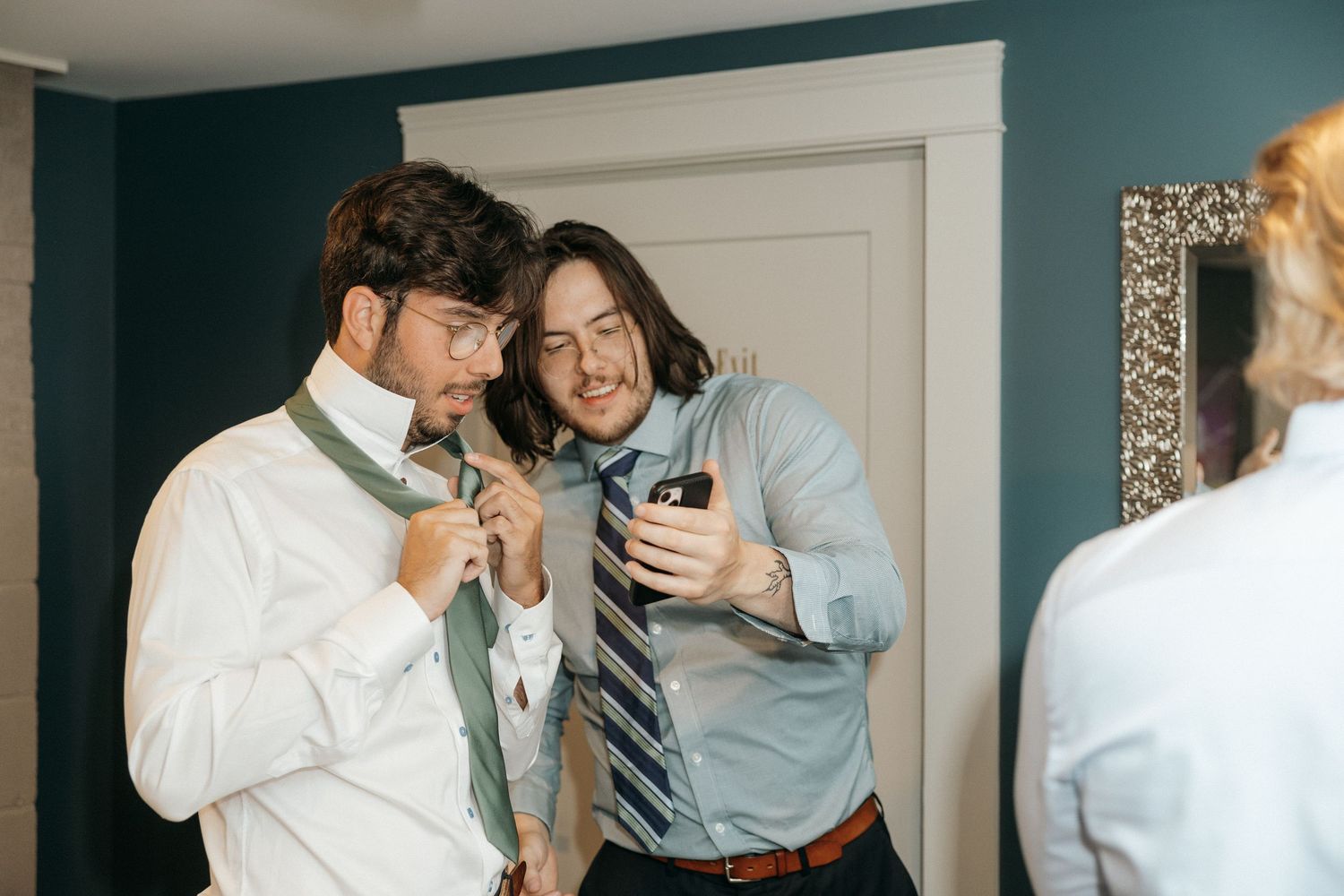 Candid moments captured in a room with teal walls.
