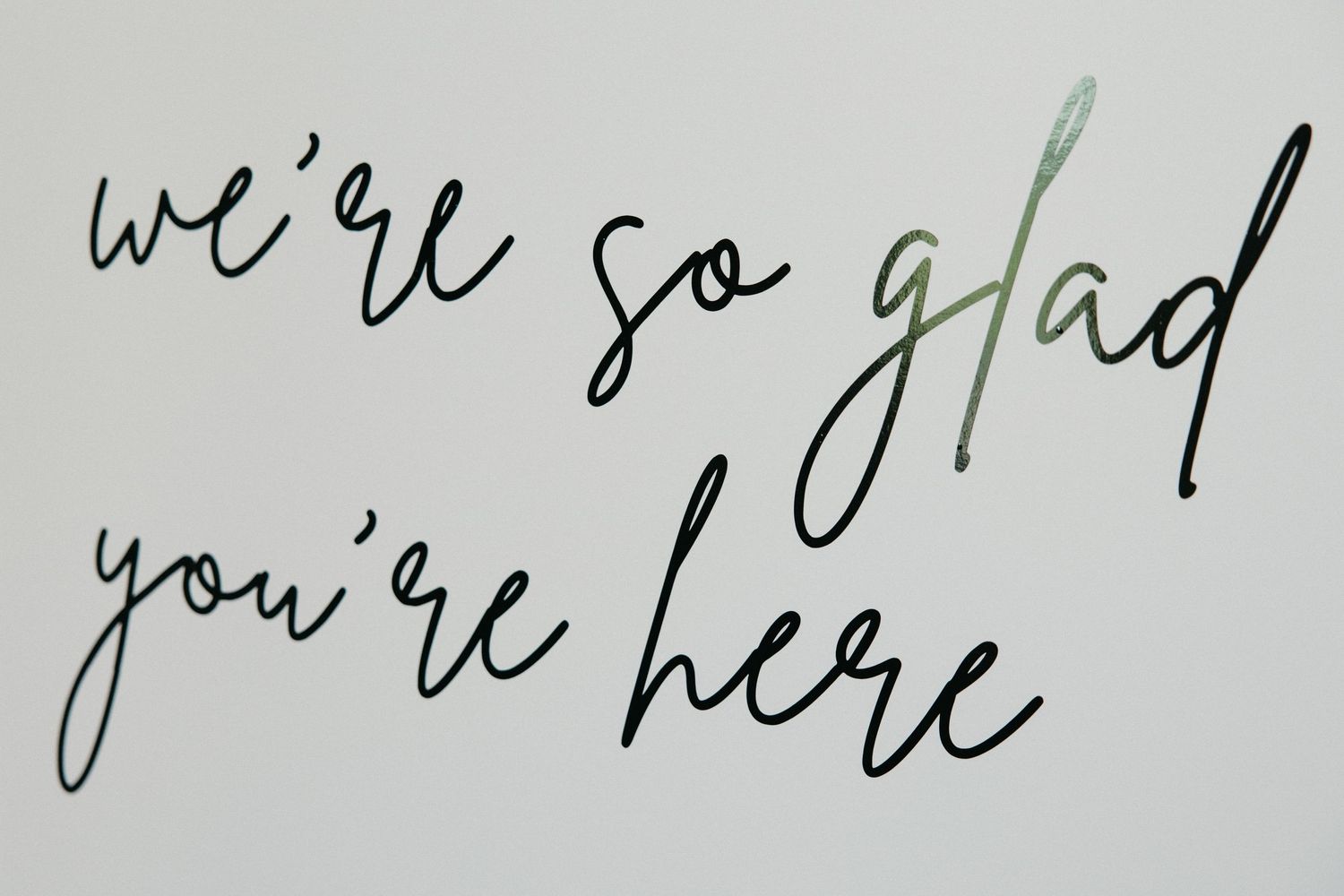 Handwritten wedding message in black ink on white paper.