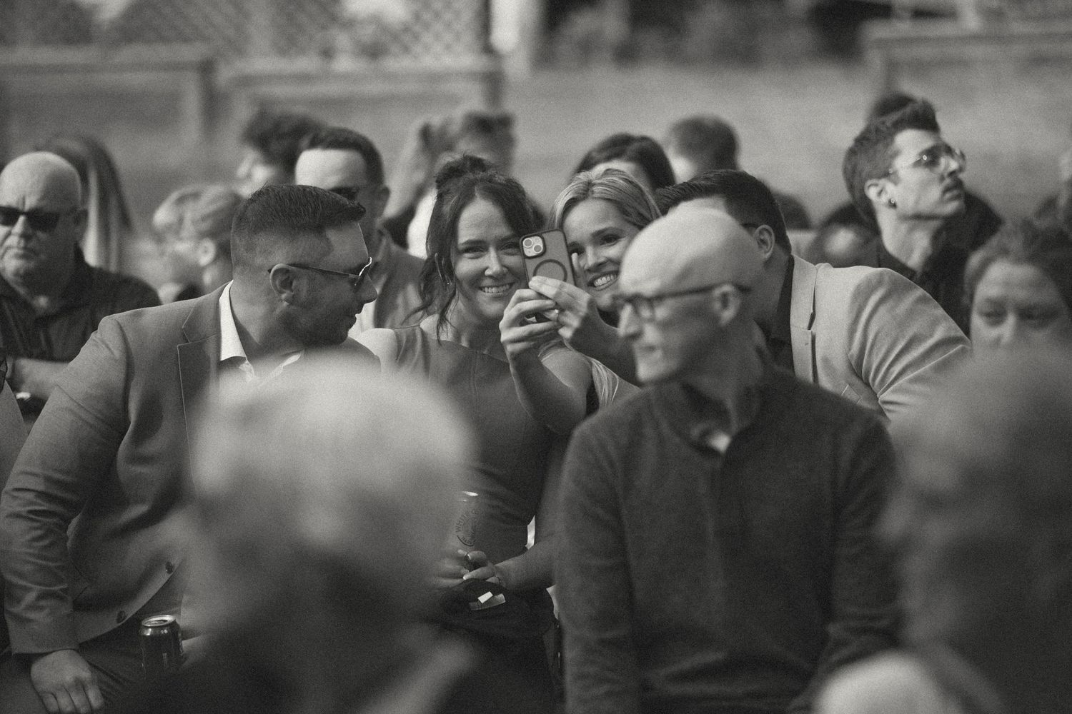 A crowd of wedding guests socializing at an outdoor reception.