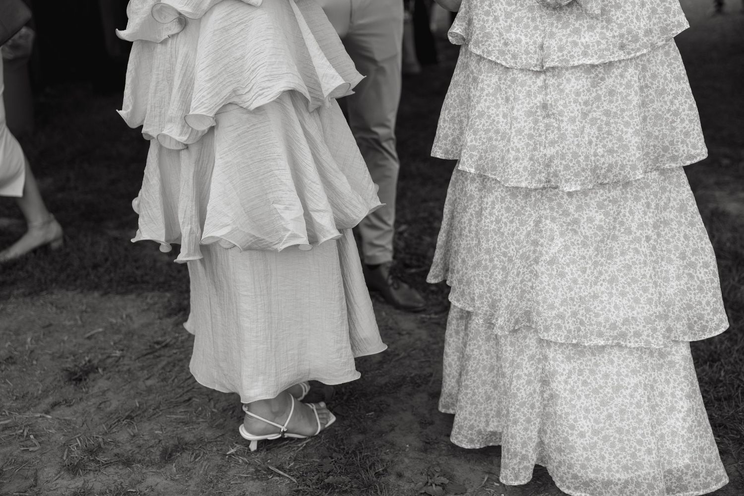 Flowing white and floral dresses captured in an artistic black and white sequence.