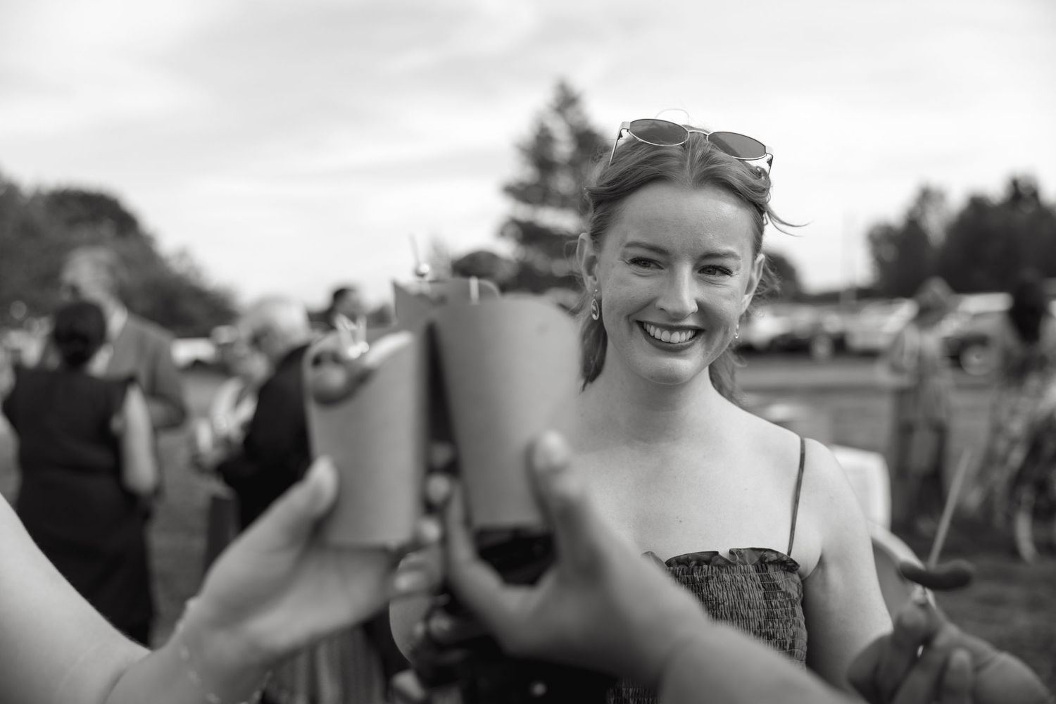 Wedding guests enjoying drinks and conversation at an outdoor cocktail reception.