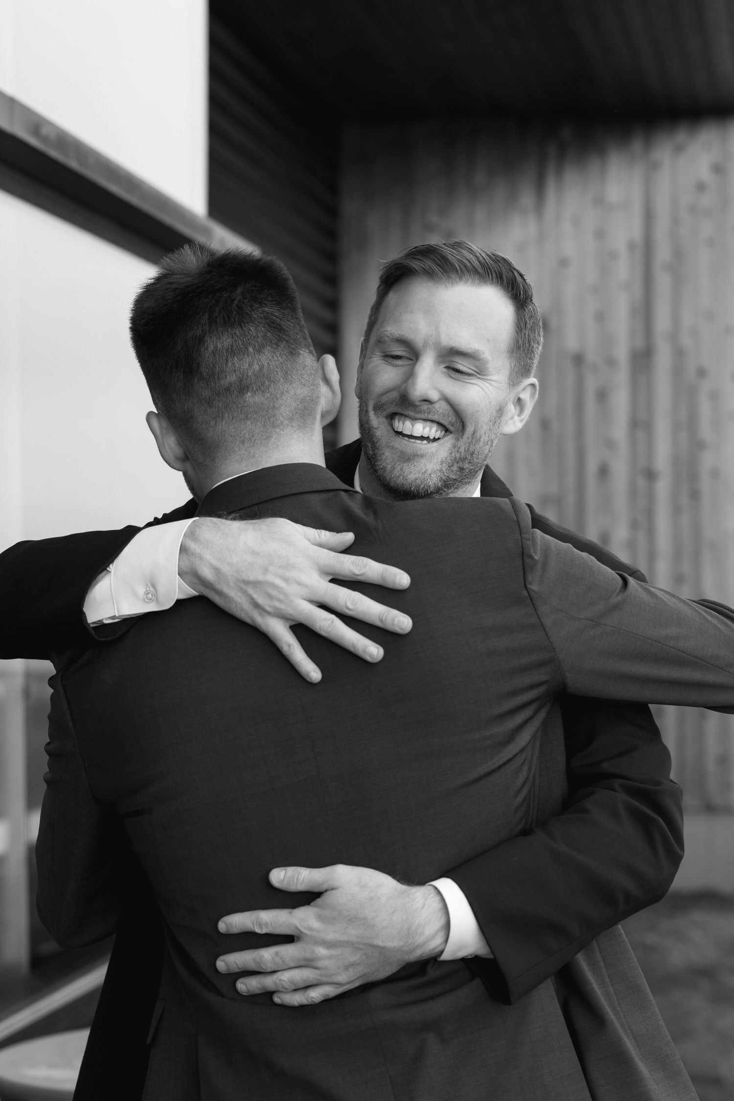A series of black and white photos showing two people embracing warmly.
