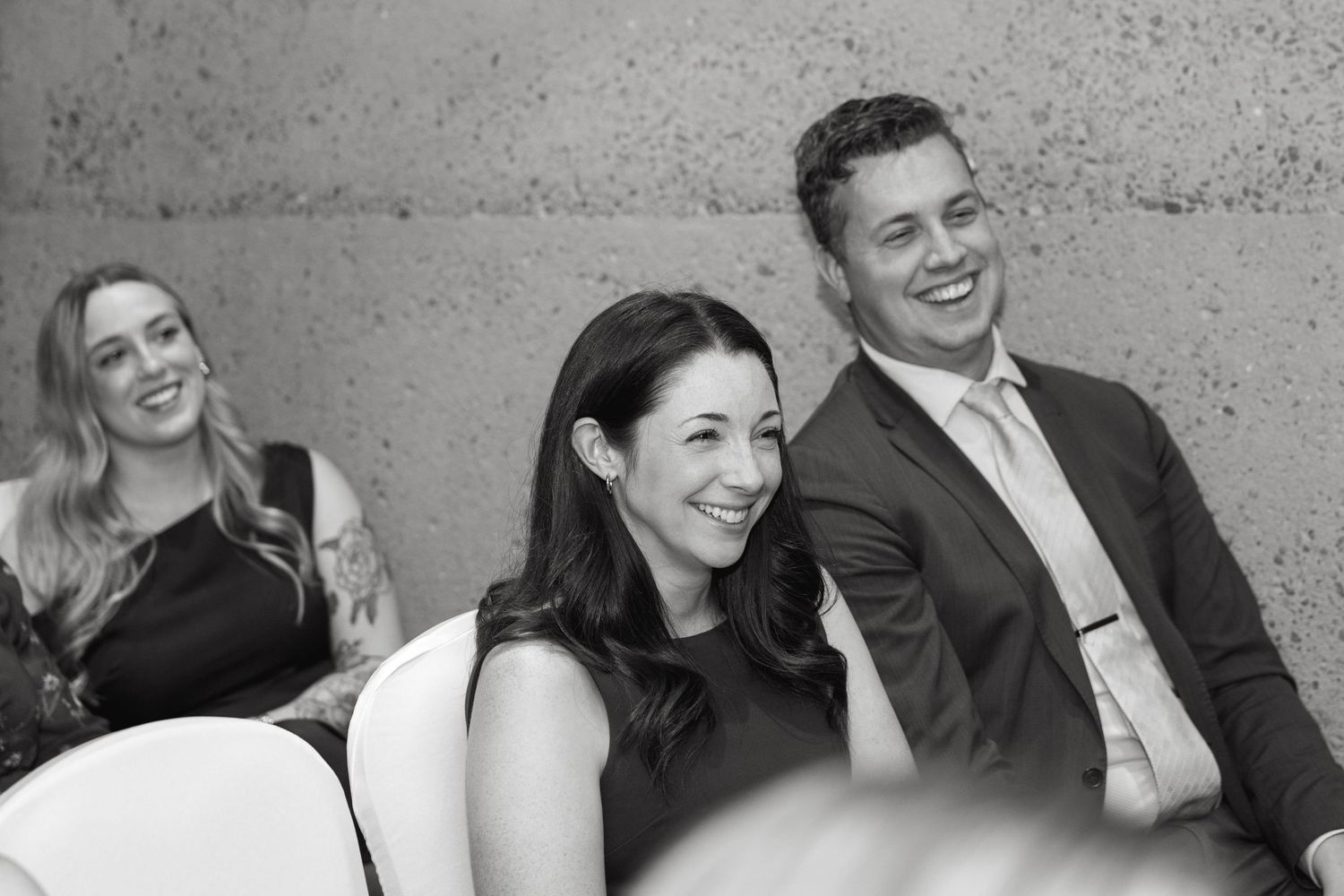 Wedding guests share joyful moments and laughter during an elegant celebration.