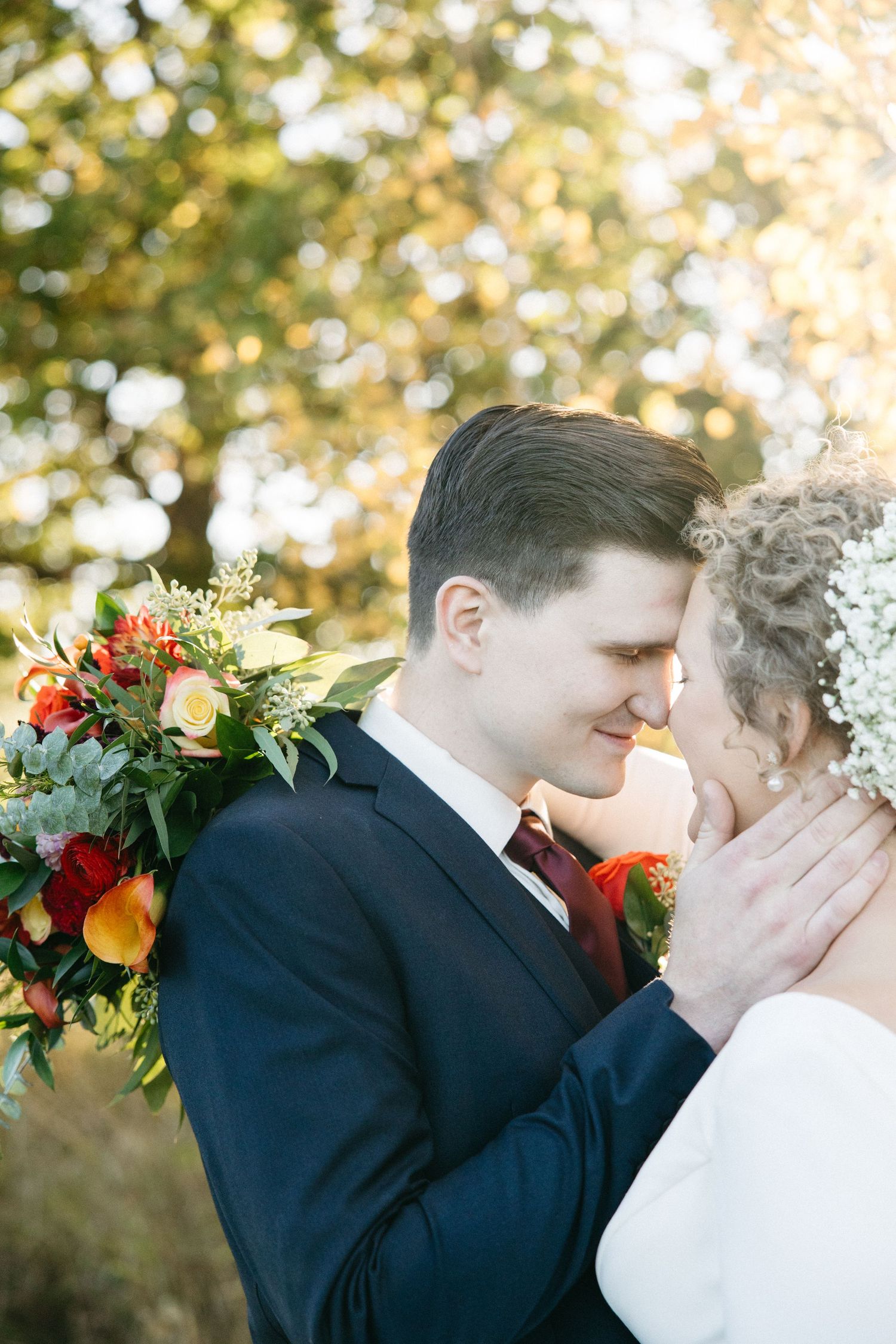 A romantic first look sequence between newlyweds sharing an intimate moment against a fall backdrop.