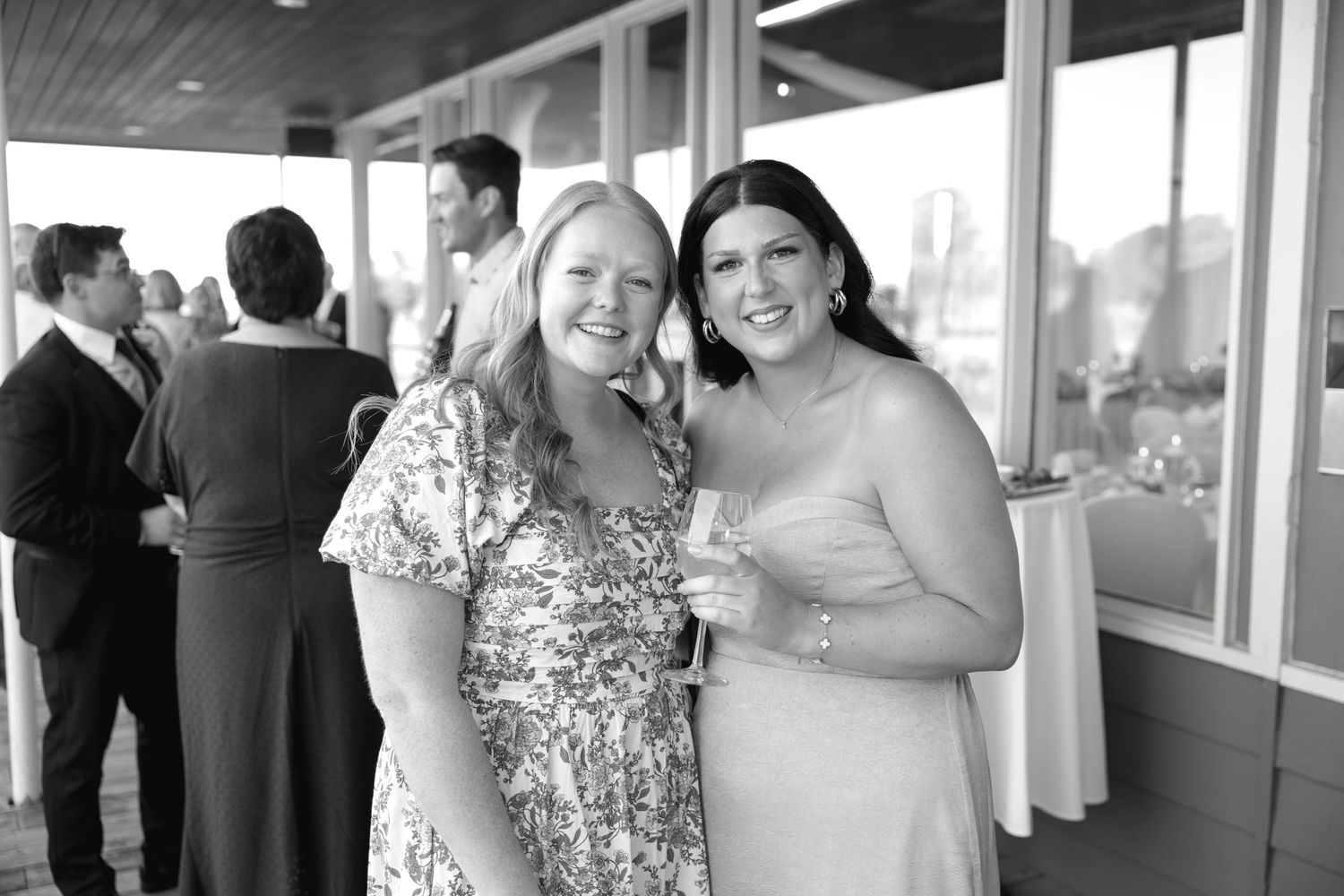 Wedding guests mingle and socialize during an outdoor reception celebration.