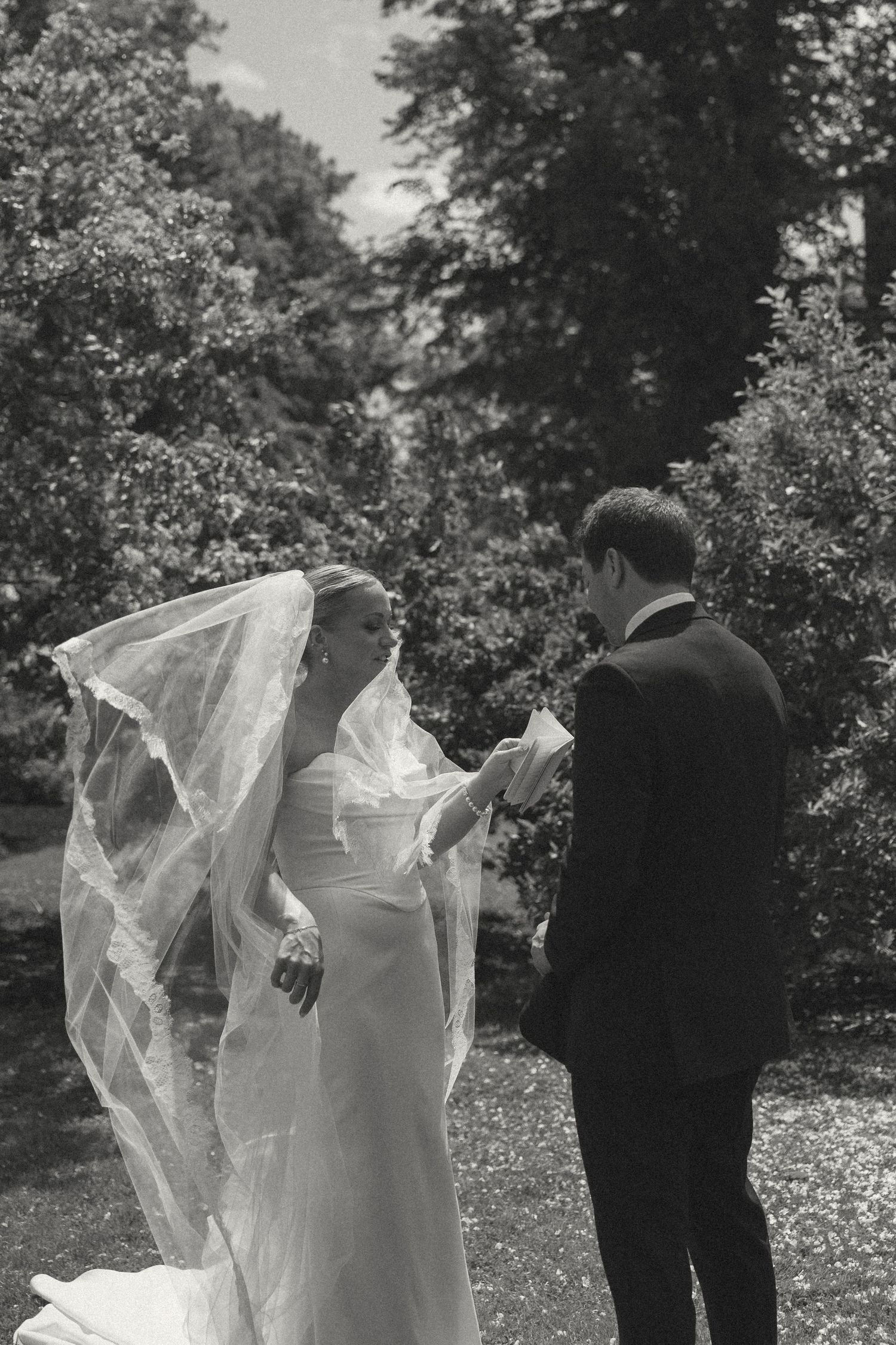 Wedding couple in black and white sharing intimate moments outdoors.