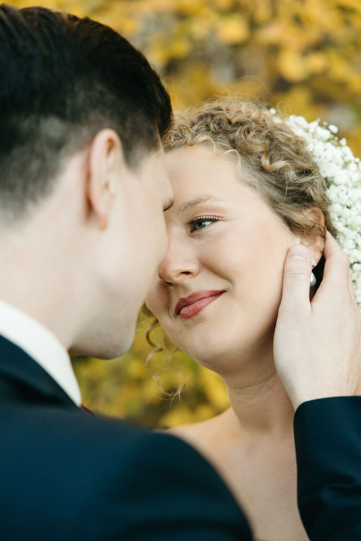 Romantic close-up wedding portraits with golden autumn bokeh background.