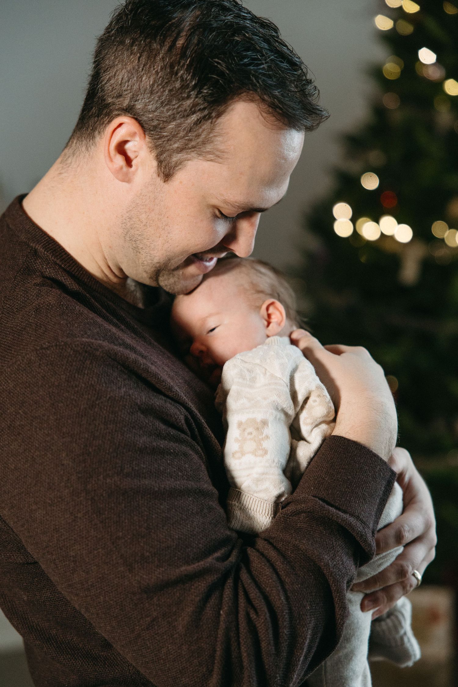 Close-up shots of tender parenting moments in a festively decorated space.