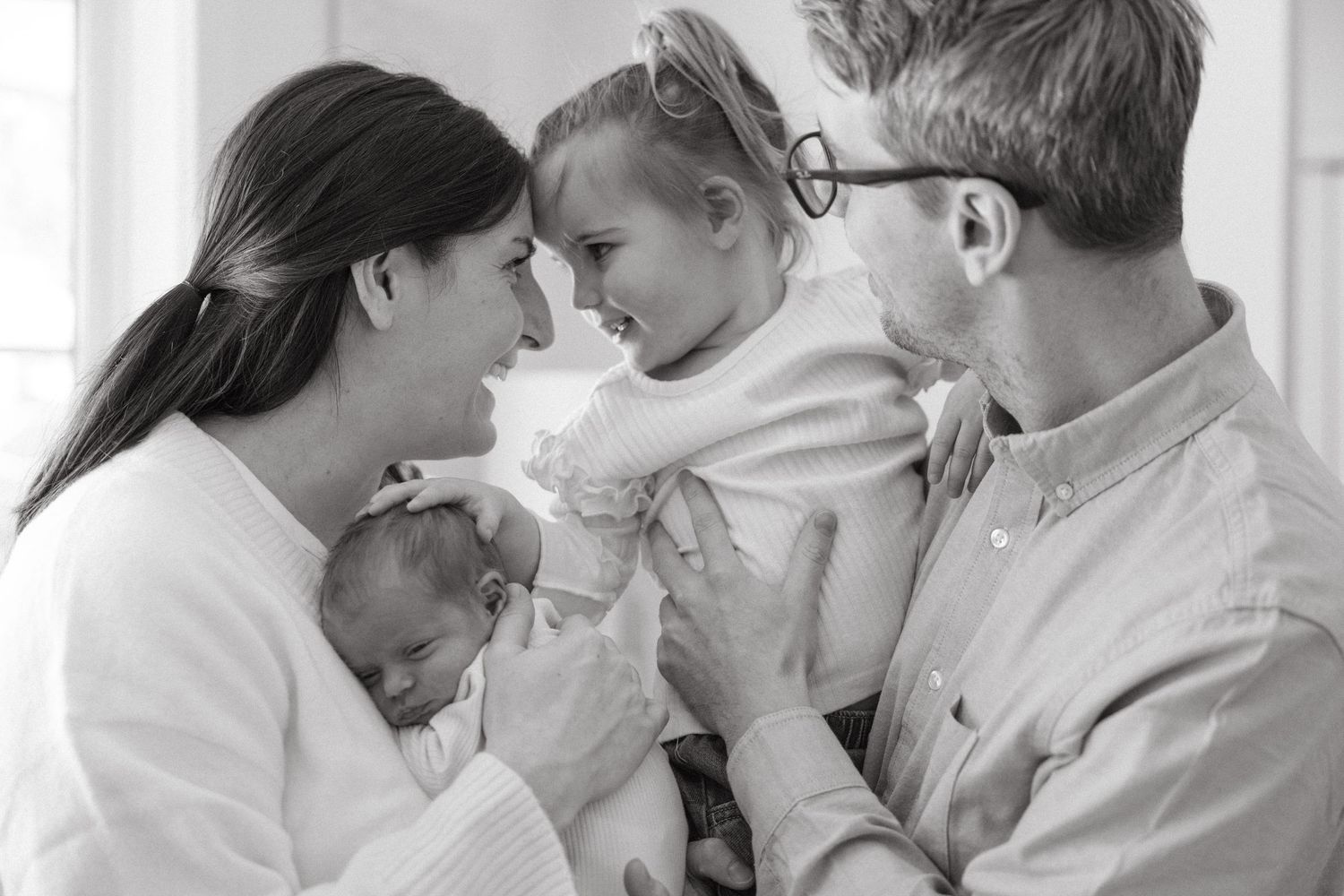 A series of black and white photos showing tender moments between couples in romantic poses.