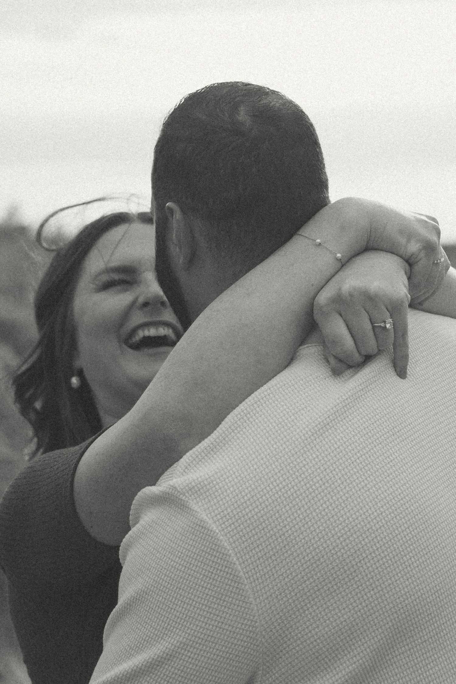 A romantic black and white photo sequence showing an intimate embrace between a couple at sunset.