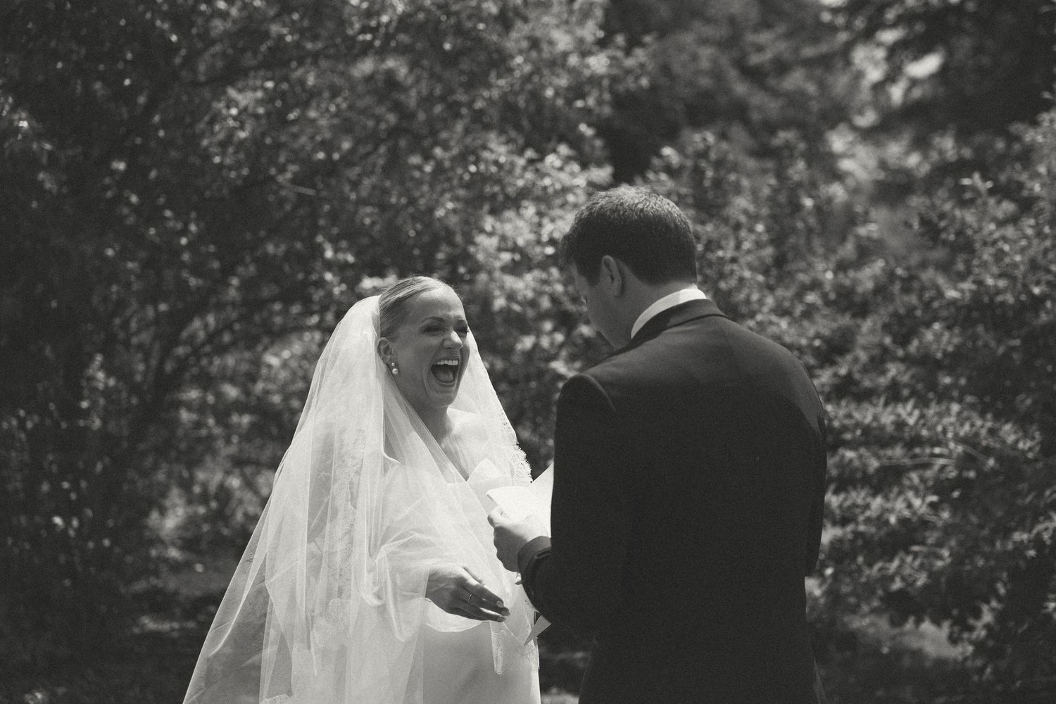 Black and white romantic wedding portraits in a garden setting.