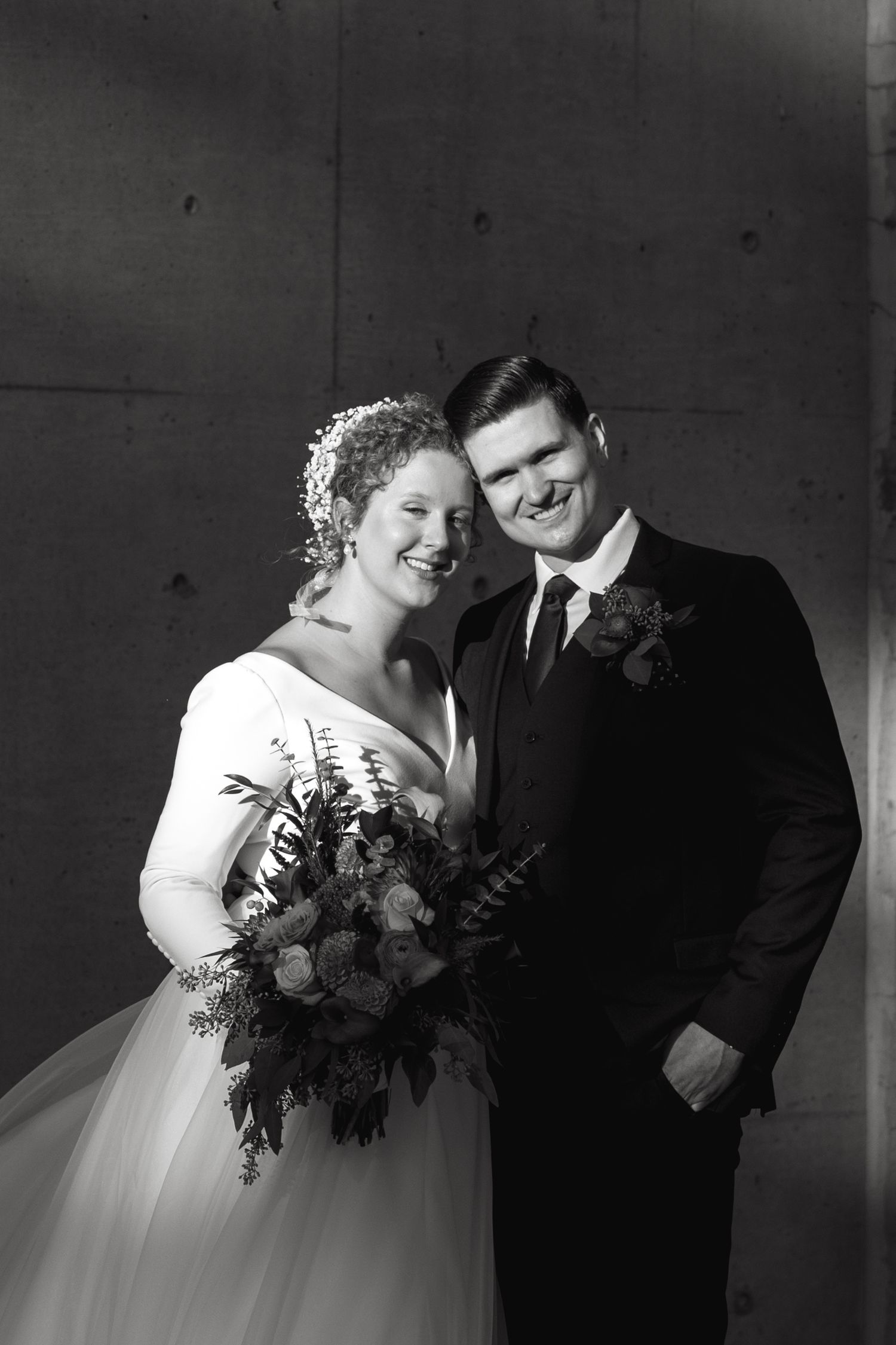 Dramatic black and white wedding portraits showing intimate moments between newlyweds.