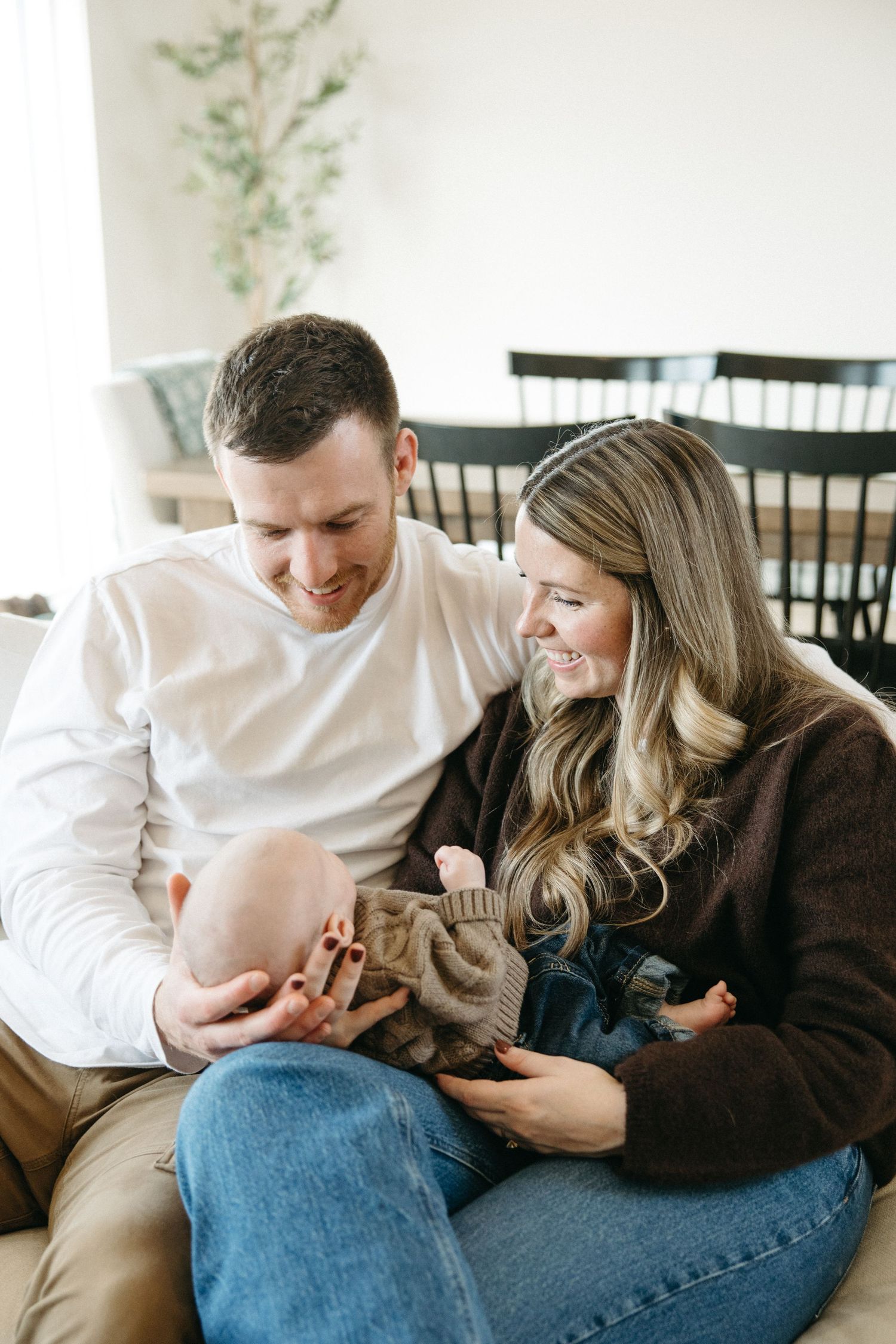 A couple shares a tender moment on their couch during the holidays.