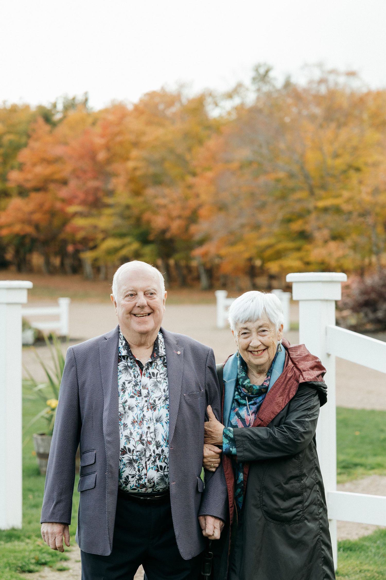 Autumn scene with colorful fall foliage and people enjoying the outdoors.
