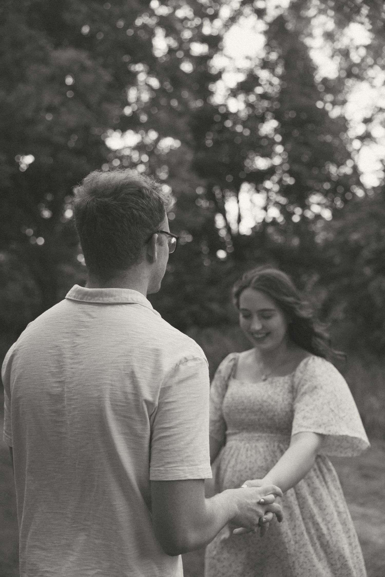 A series of natural candid moments between a couple in a wooded area at sunset.