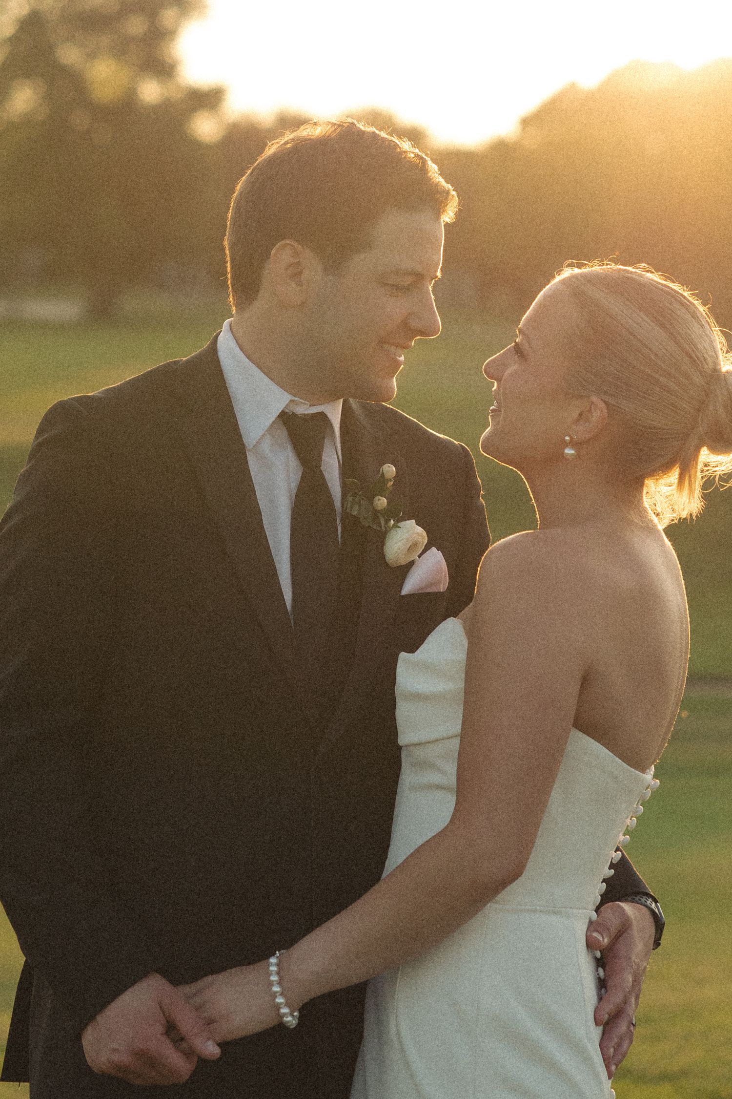 Romantic sunset portrait of newlyweds on their wedding day.
