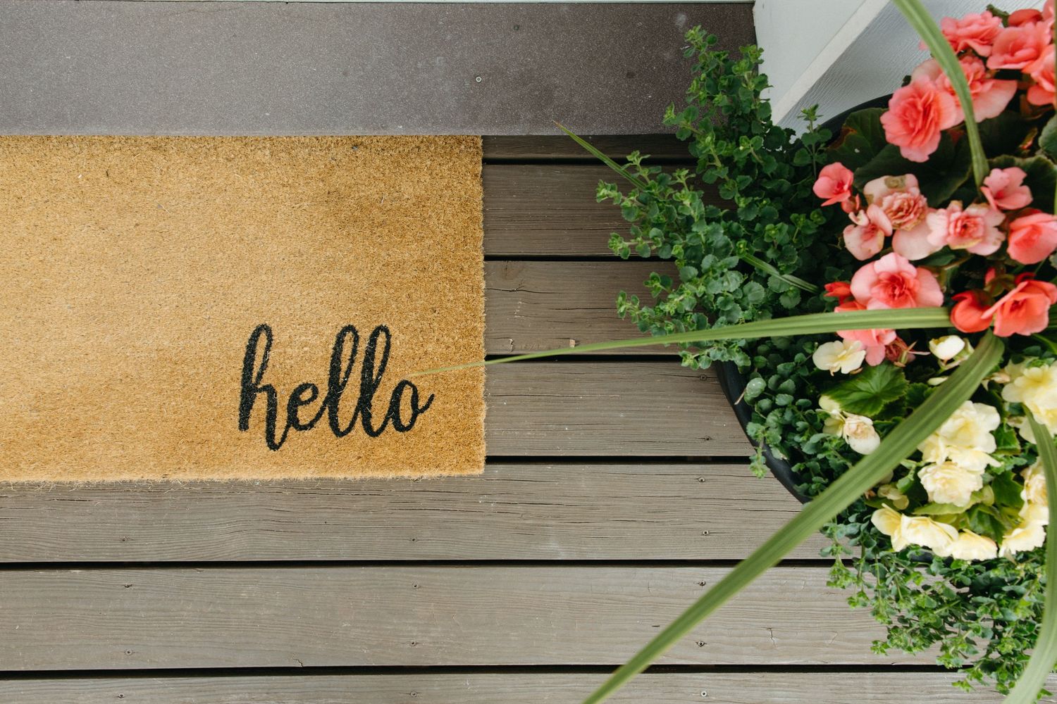 Decorative floral arrangements and signage displayed on rustic wooden background.