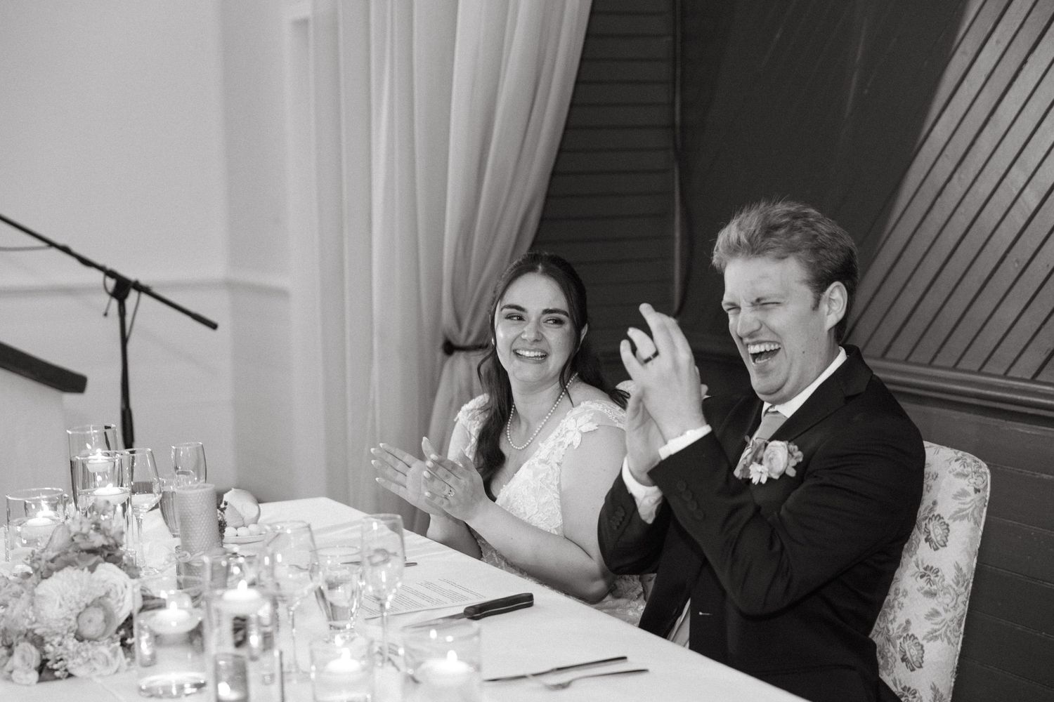 Wedding reception scene with elegant white decor and ambient lighting.