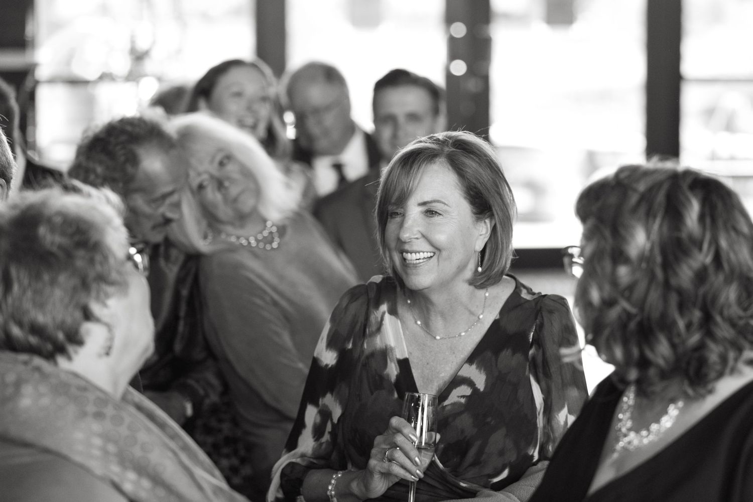 Reception guests engaged in lively conversation at a formal gathering.