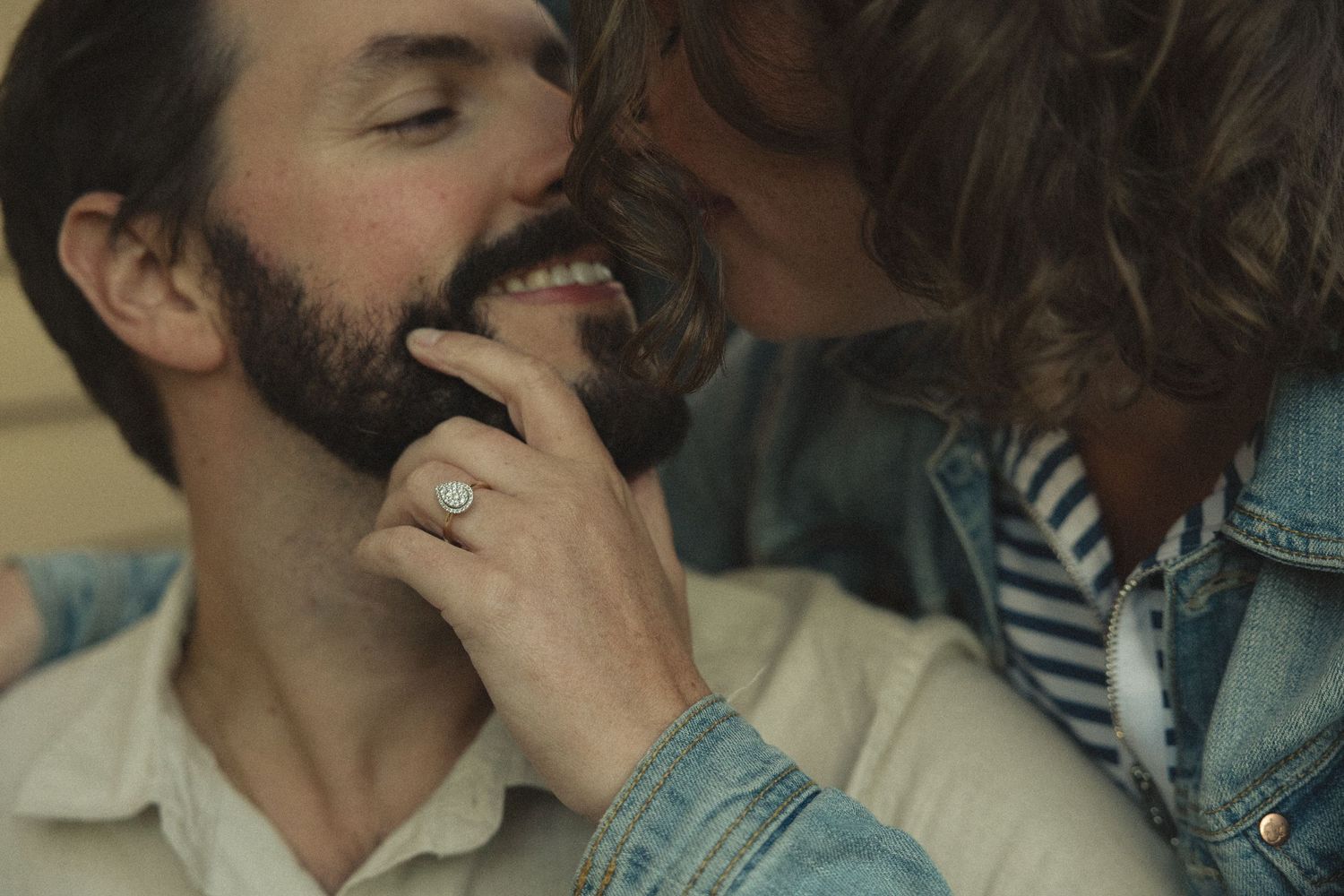 Intimate close-up moment between two people wearing casual attire.