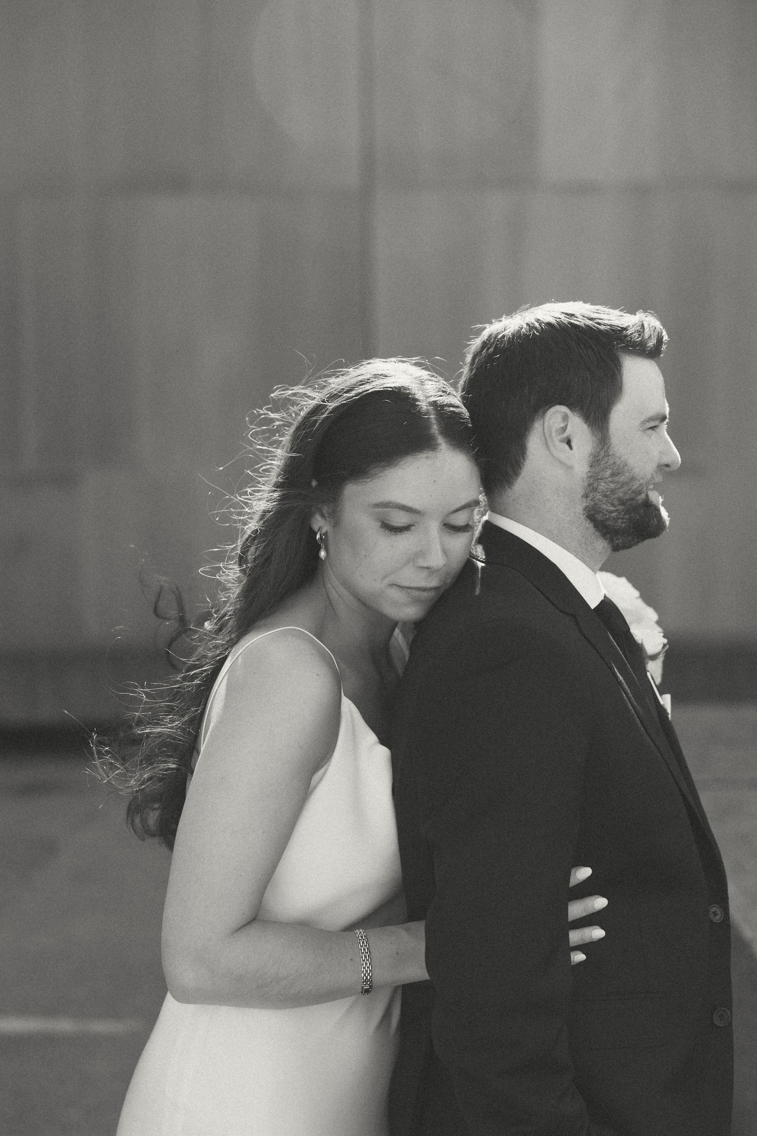 Elegant black and white wedding portrait with dramatic lighting.