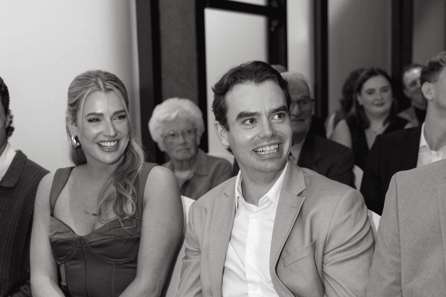 Guests seated at formal event with elegant decor and lighting.