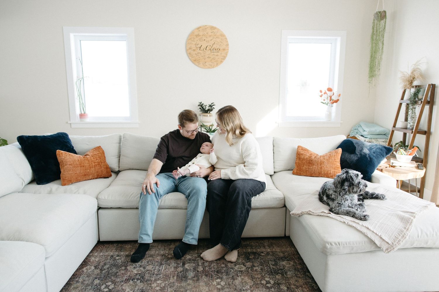A series of connected photos shows someone lounging on a white couch with a dog in a bright, modern living room.