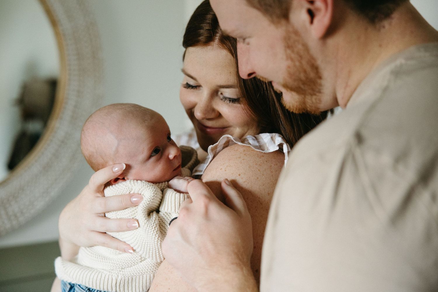 Intimate moments captured in soft natural light during a home photoshoot.