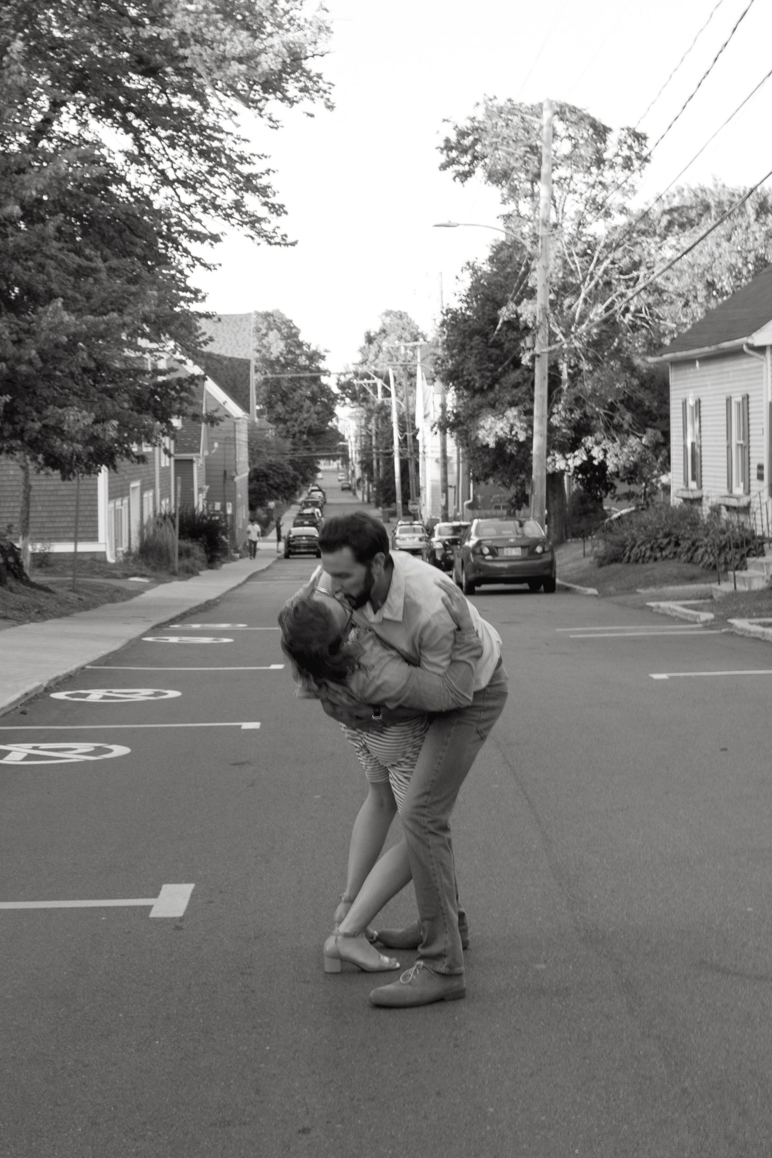 A romantic dance sequence taking place on a quiet suburban street.