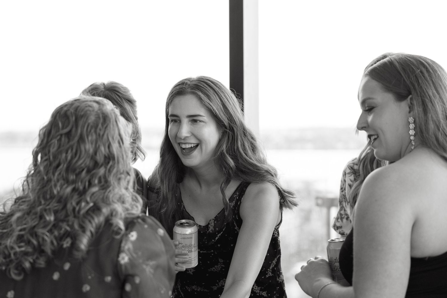 Joyful candid moments captured between guests at a formal celebration.