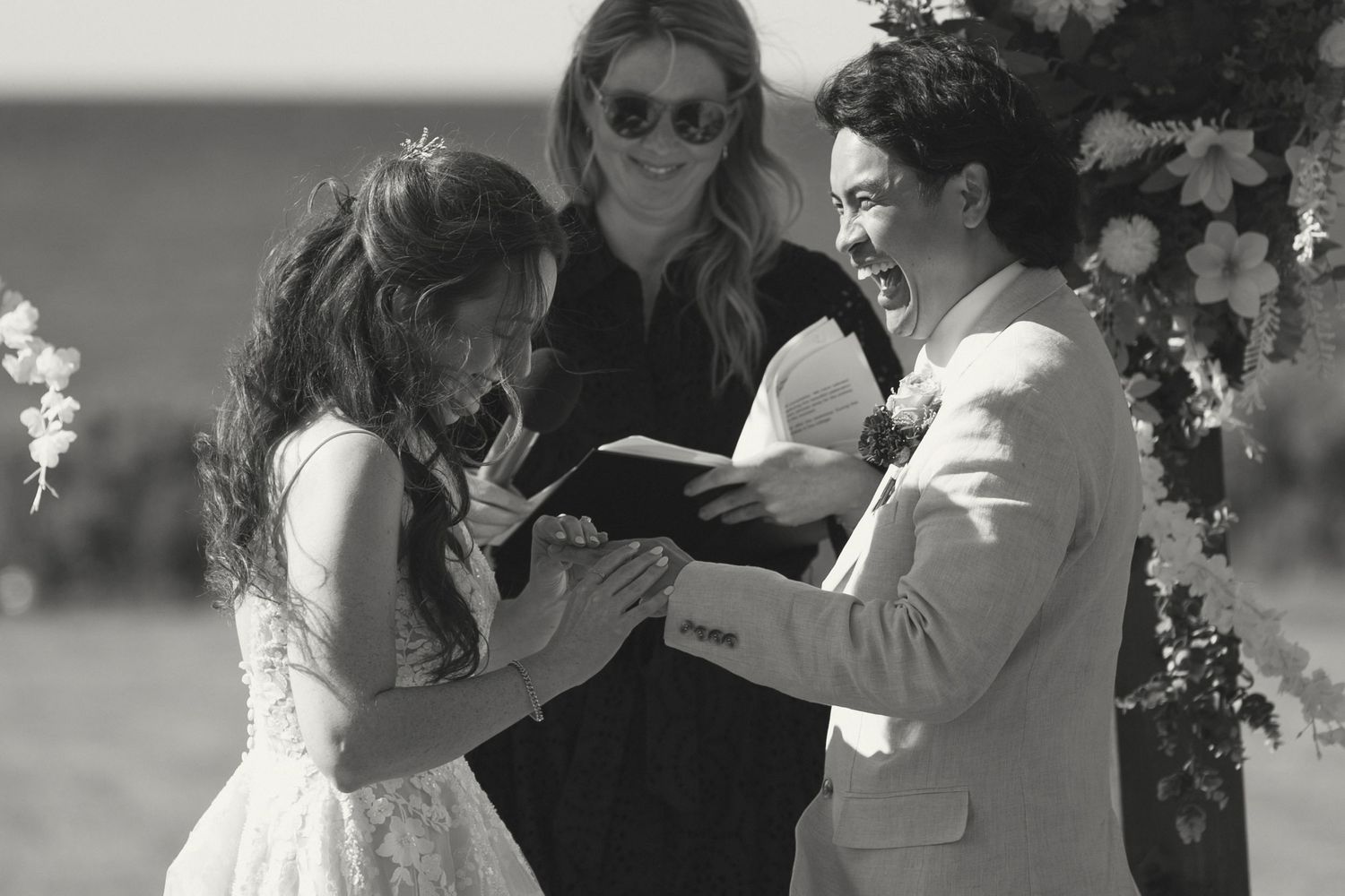 Wedding ceremony filled with laughter during vow exchange.