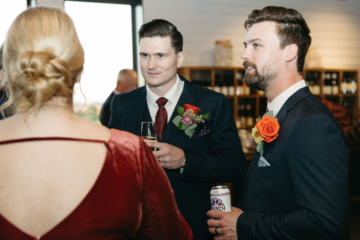 Guests in formal attire mingling at an evening reception.
