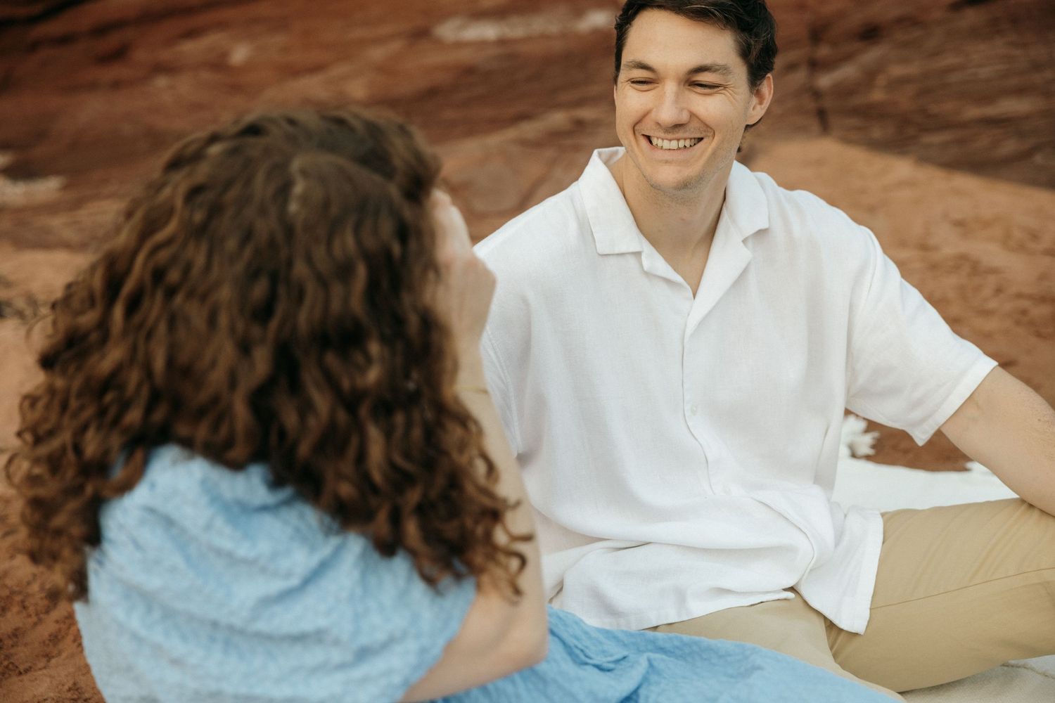 Close-up romantic photo session moments captured against natural red rock scenery.