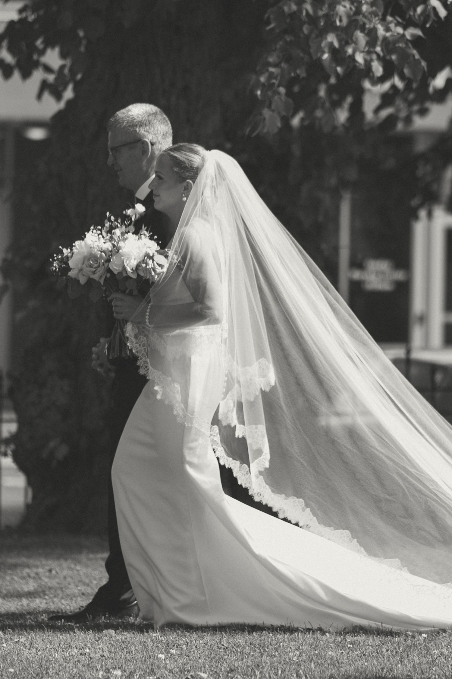 Black and white series showing flowing bridal veil movement in outdoor setting.