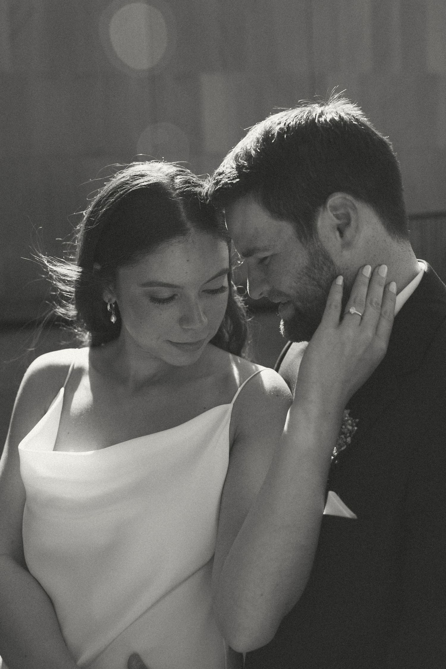 Intimate black and white portrait showcasing tender wedding moments.