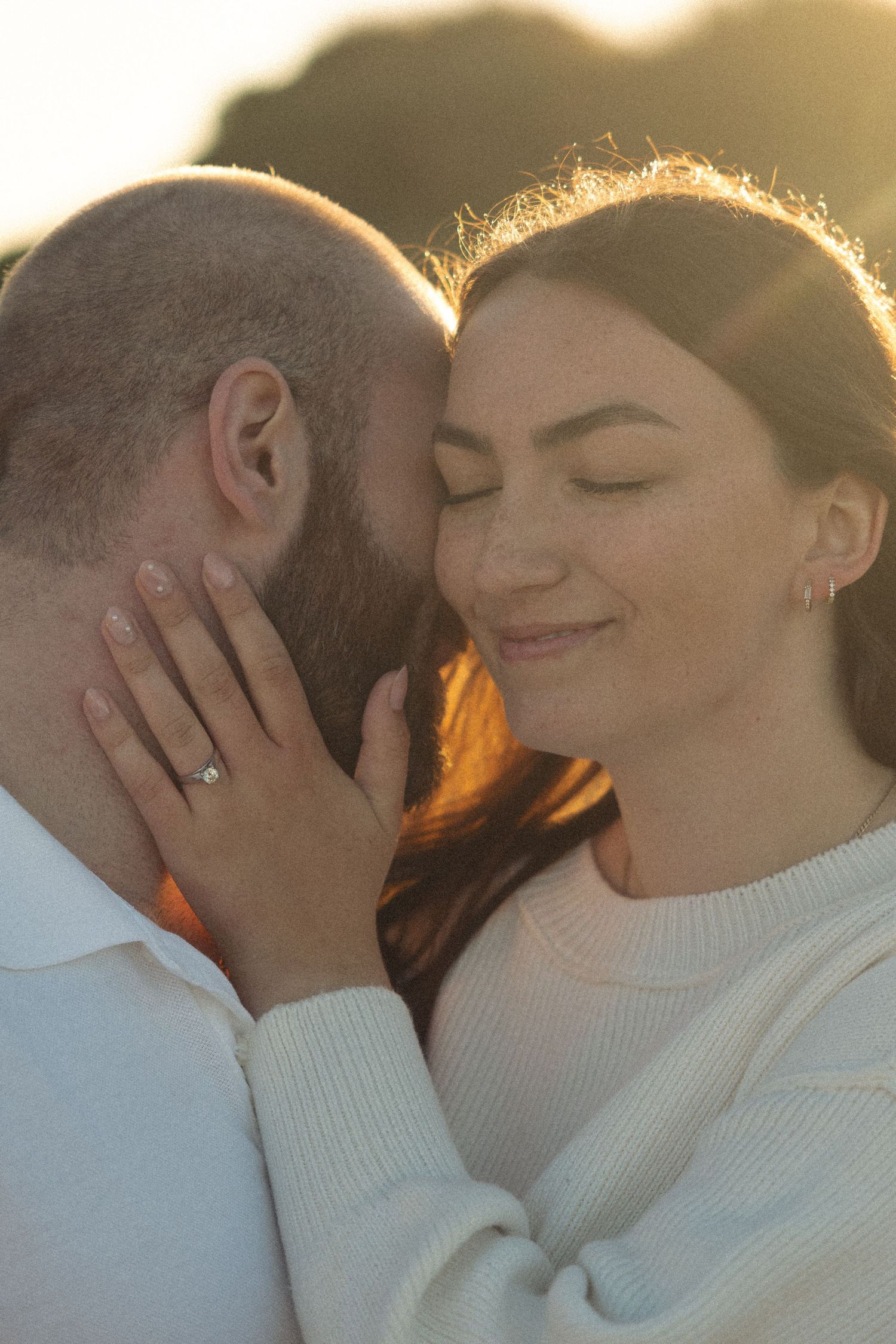 Intimate close-up photos of a couple sharing tender moments in warm sunlight.