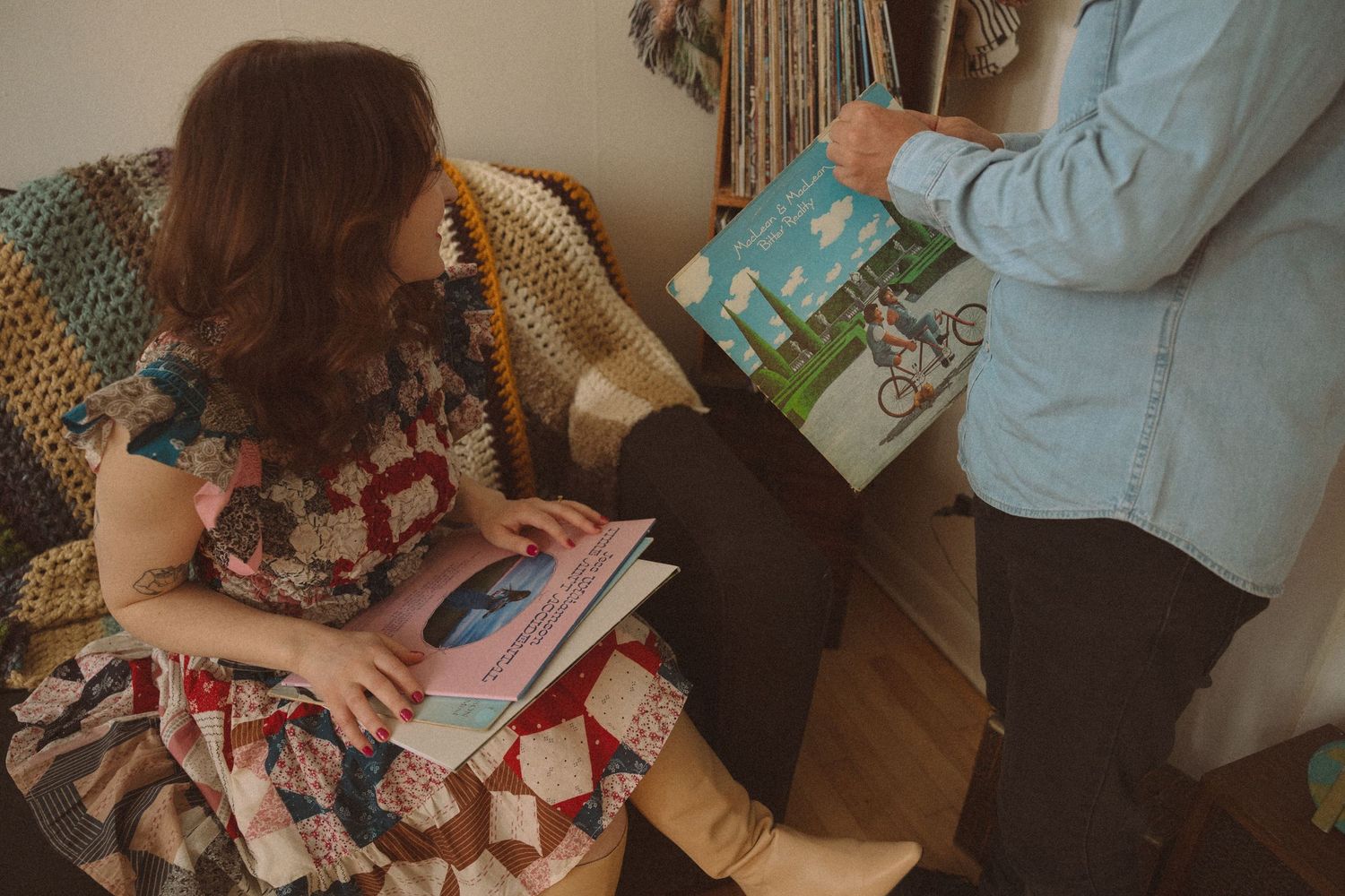 Intimate home photoshoot with couple reading and playing with cats.