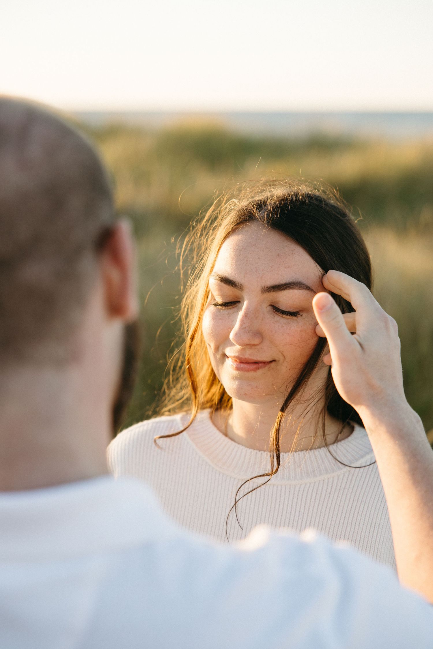 Intimate close-up portrait sequence showing tender emotional moments in golden sunlight.