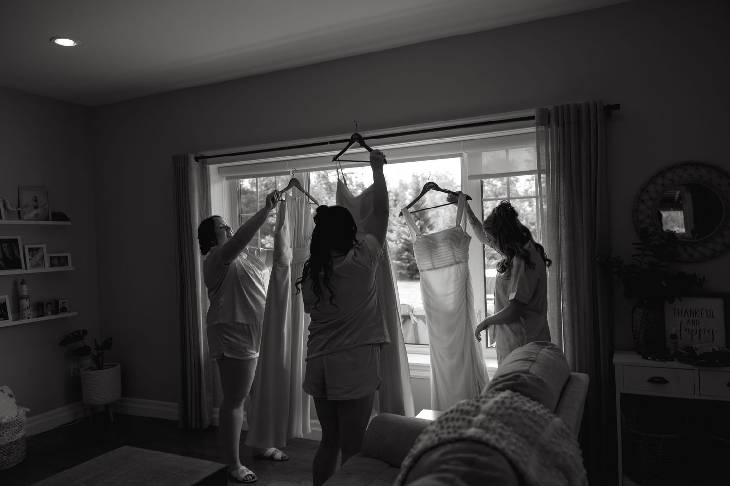 A dimly lit room with natural light streaming through windows creates a moody atmosphere.