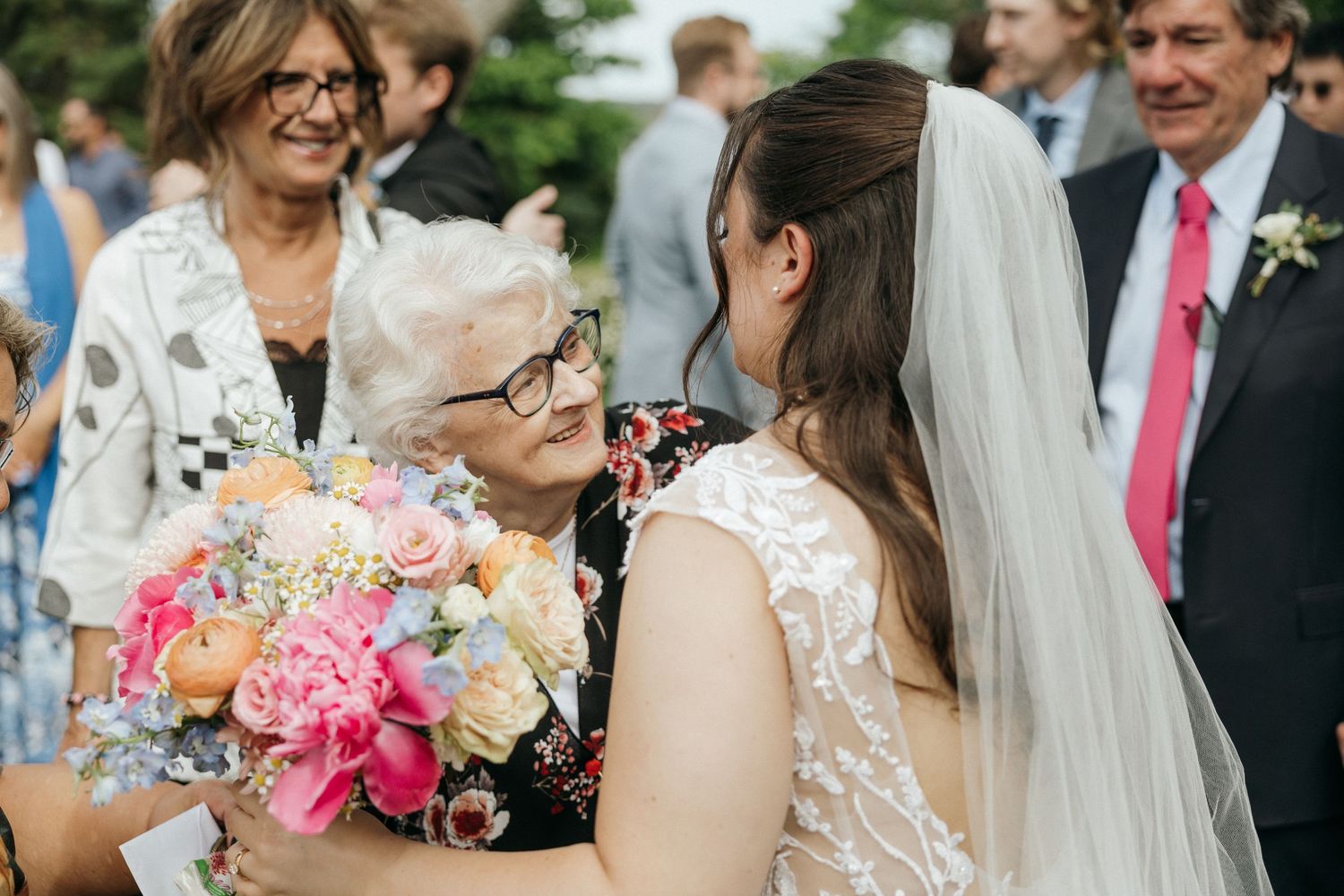 Wedding party members share joyful moments during outdoor summer celebrations.