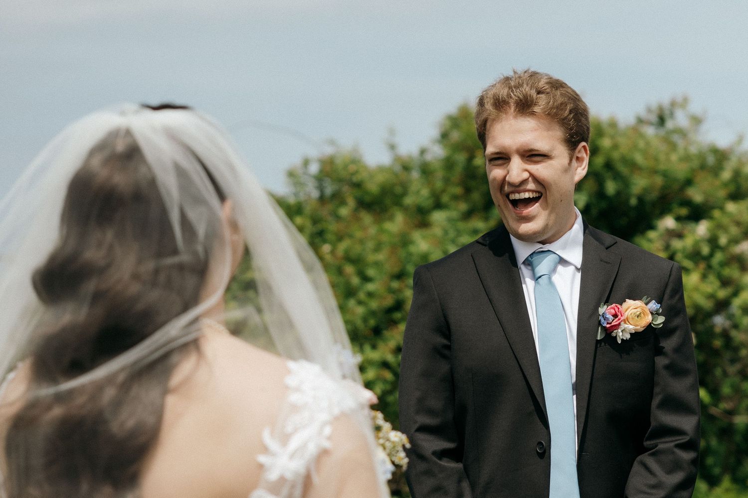 A romantic wedding moment captured against a scenic coastal backdrop.