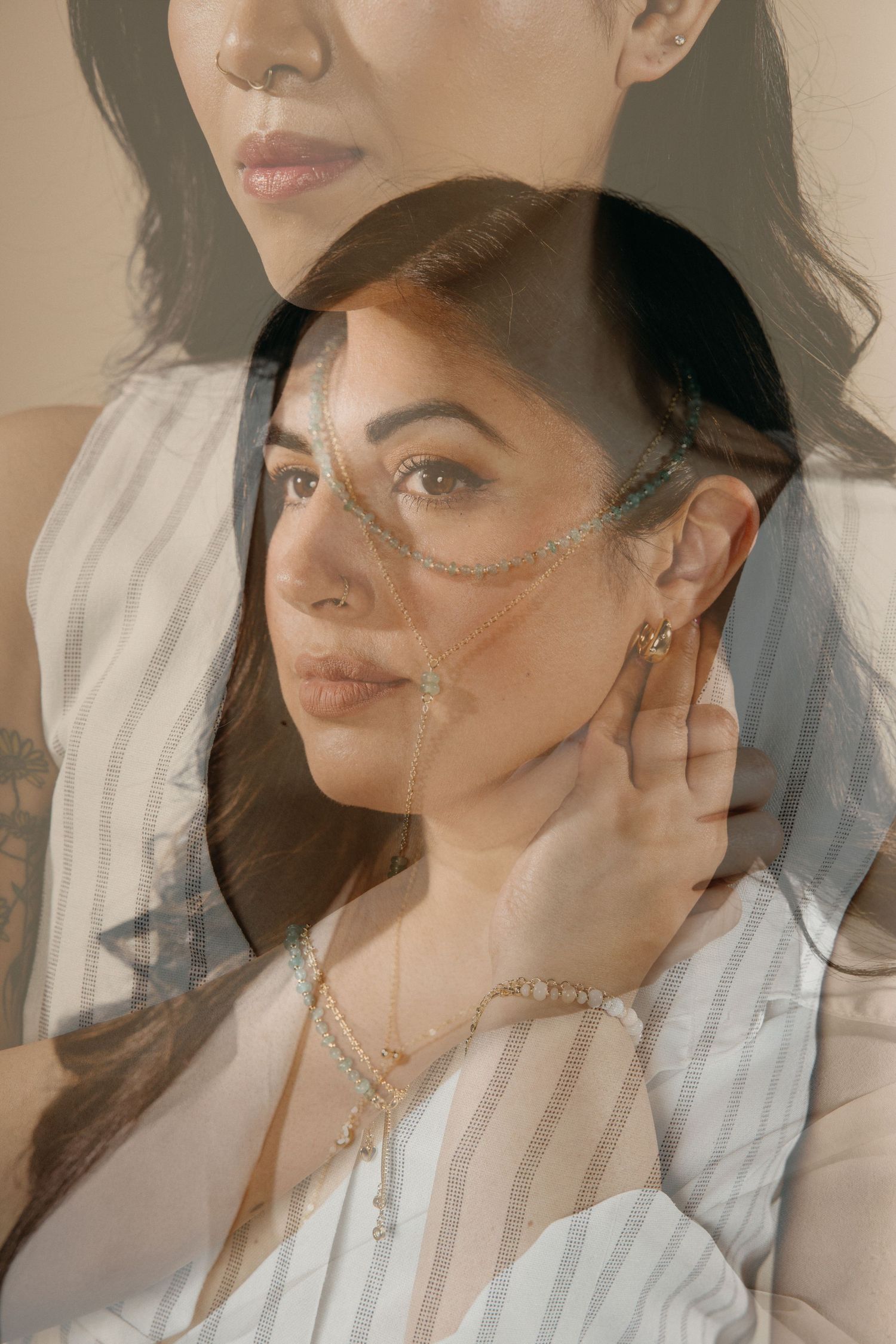 Artistic portrait series showcasing layered gold necklaces against white clothing.