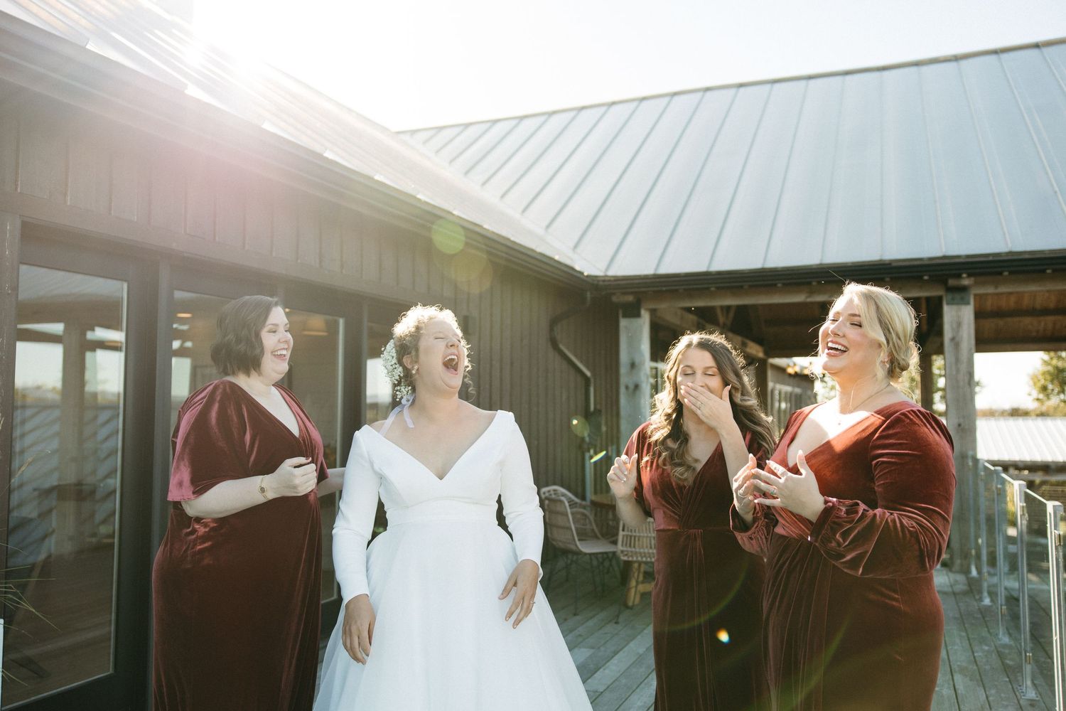 Candid wedding moments captured in golden sunlight on an outdoor deck.