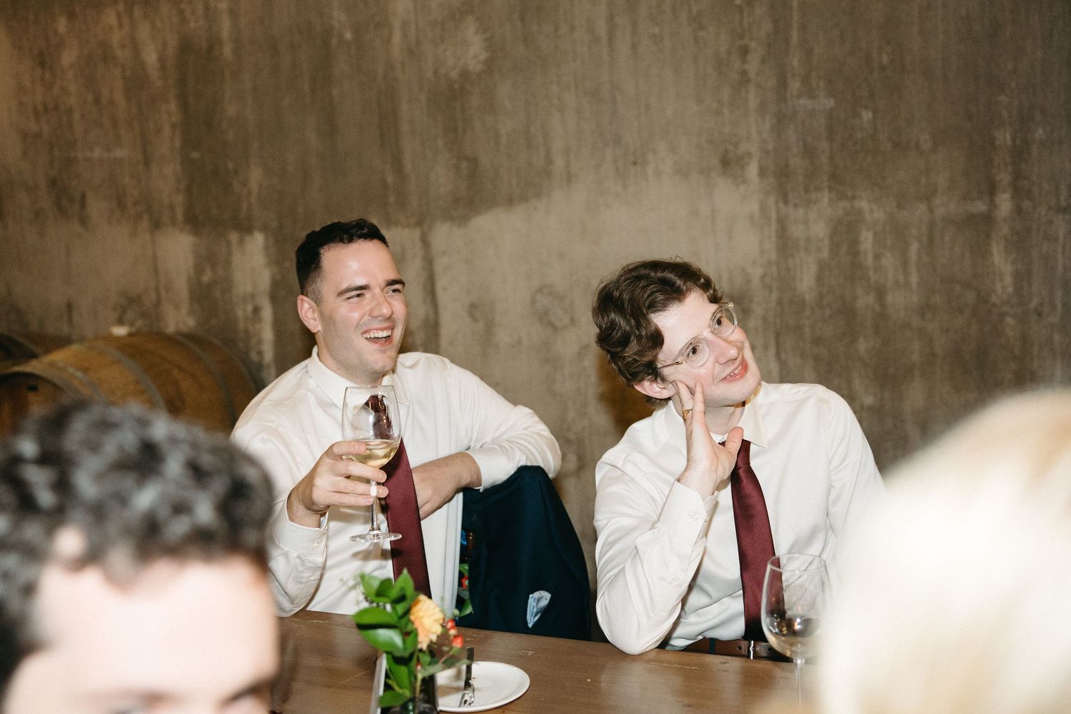 Guests enjoying conversation at a formal dinner with warm ambient lighting.