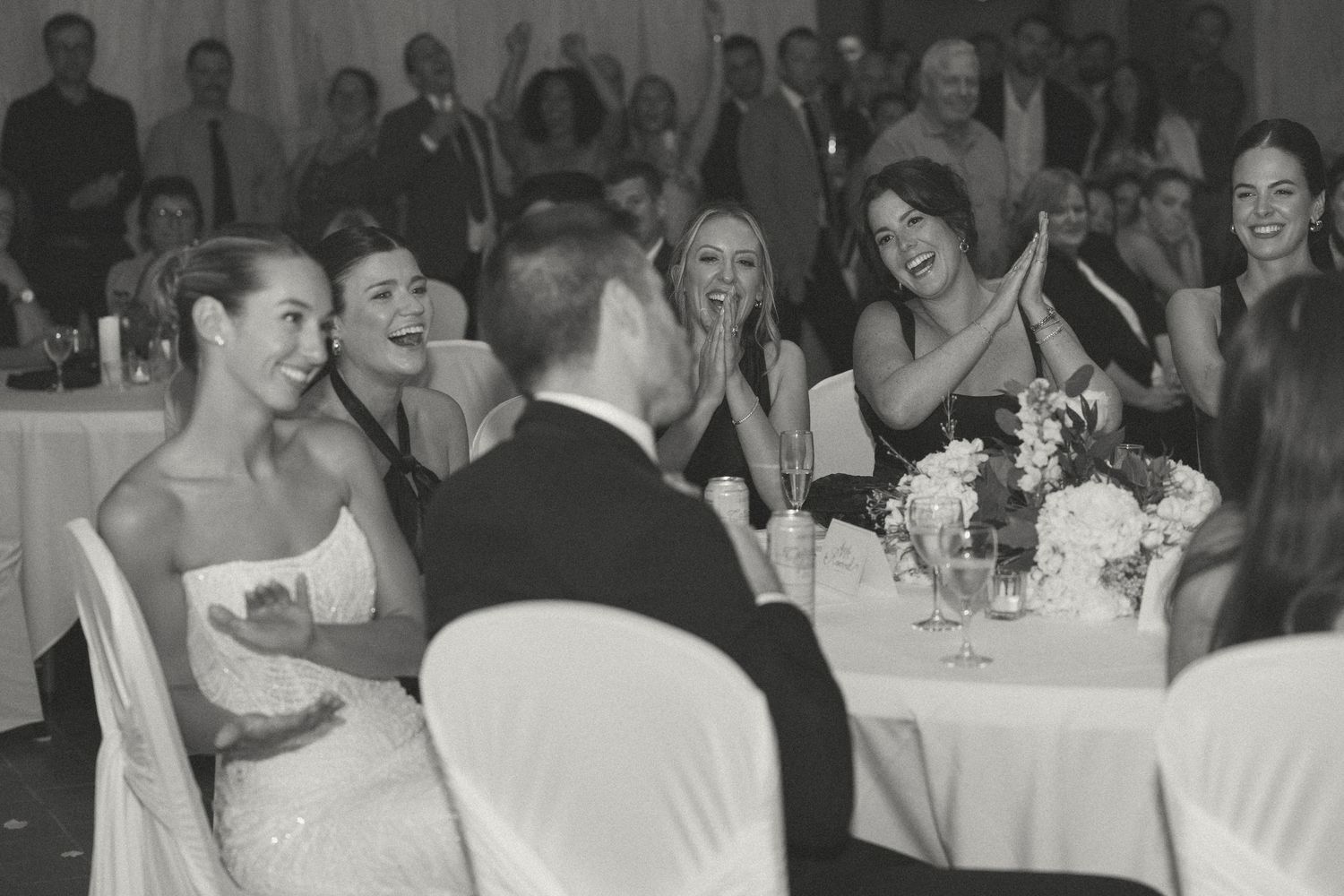 Wedding reception celebration with guests dining at decorated tables.