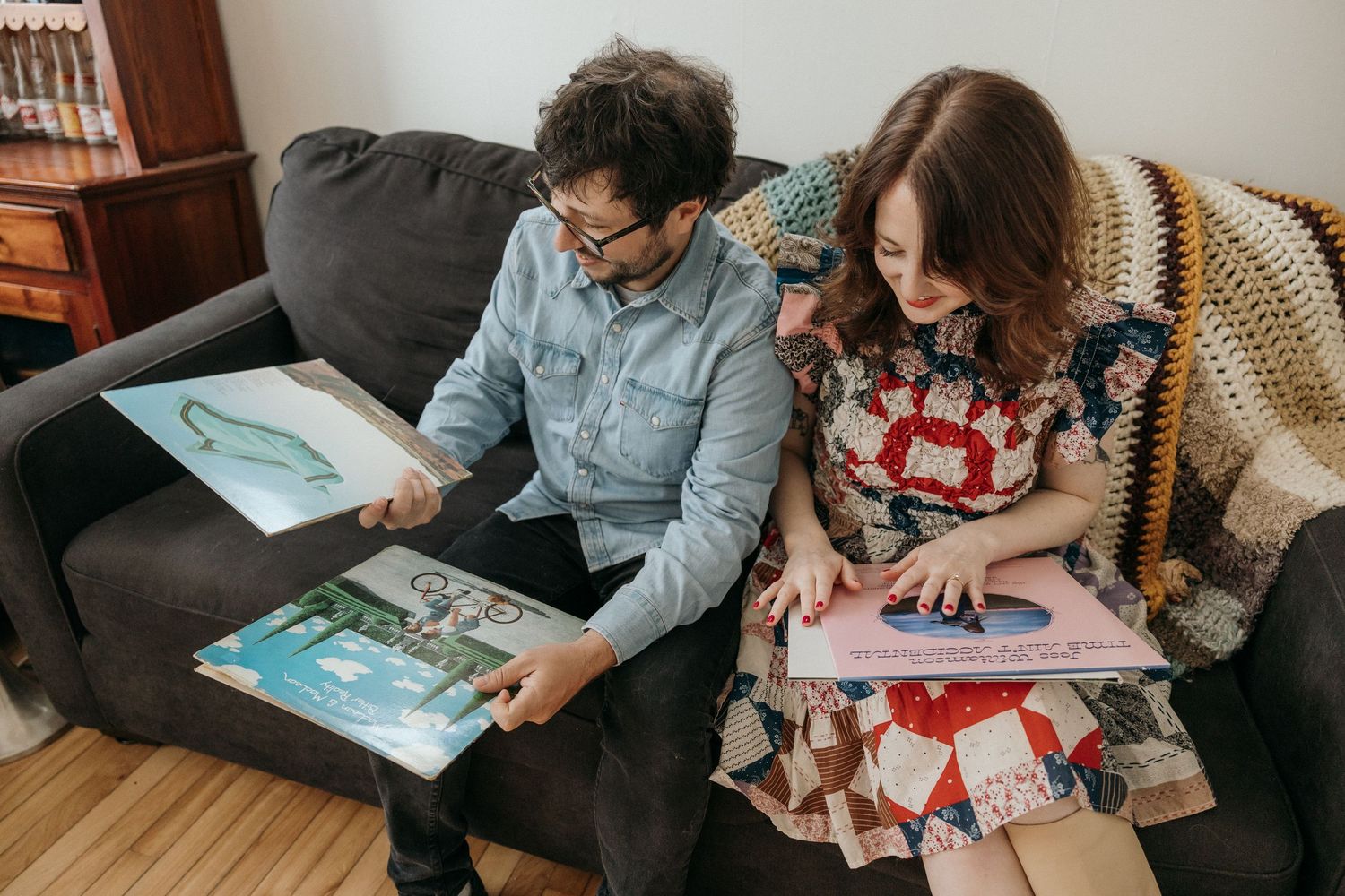 Couple shares intimate moment while reading books together indoors.
